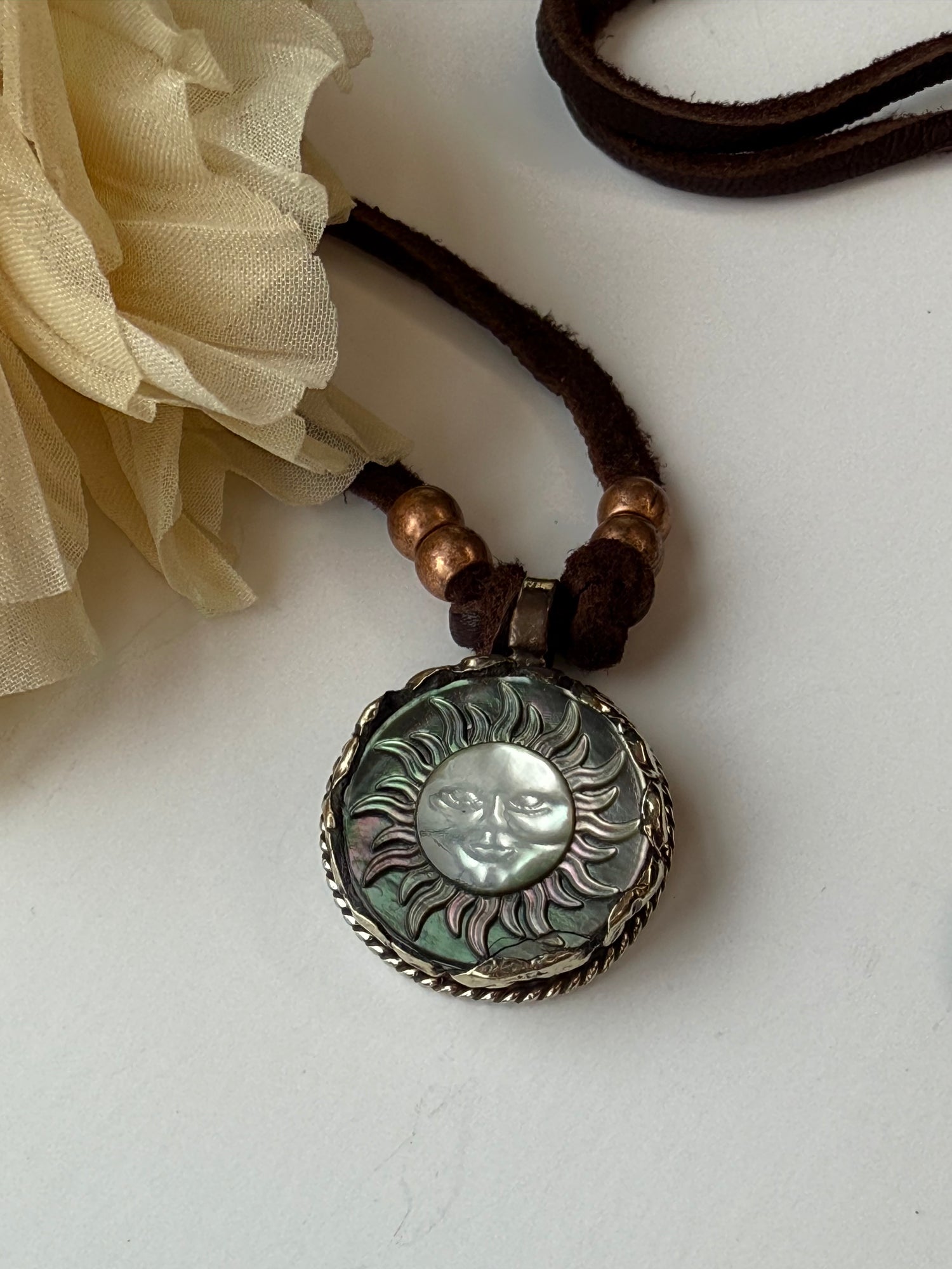 Decorative pendant with sun element on a white background