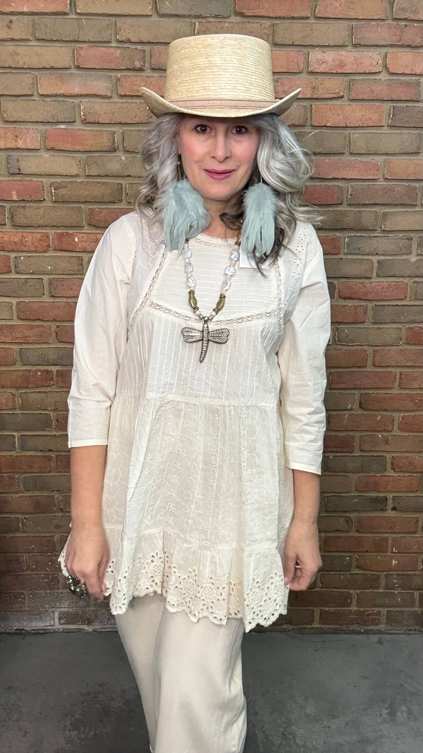 Woman wearing a Dragonfly Pendant on Pearl Necklace.