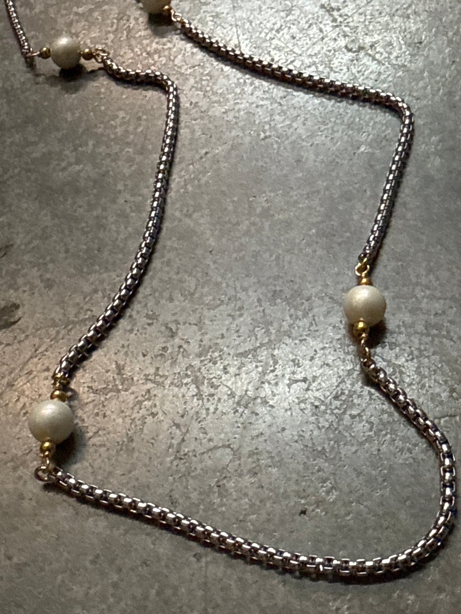 Necklace with pearls on a textured surface
