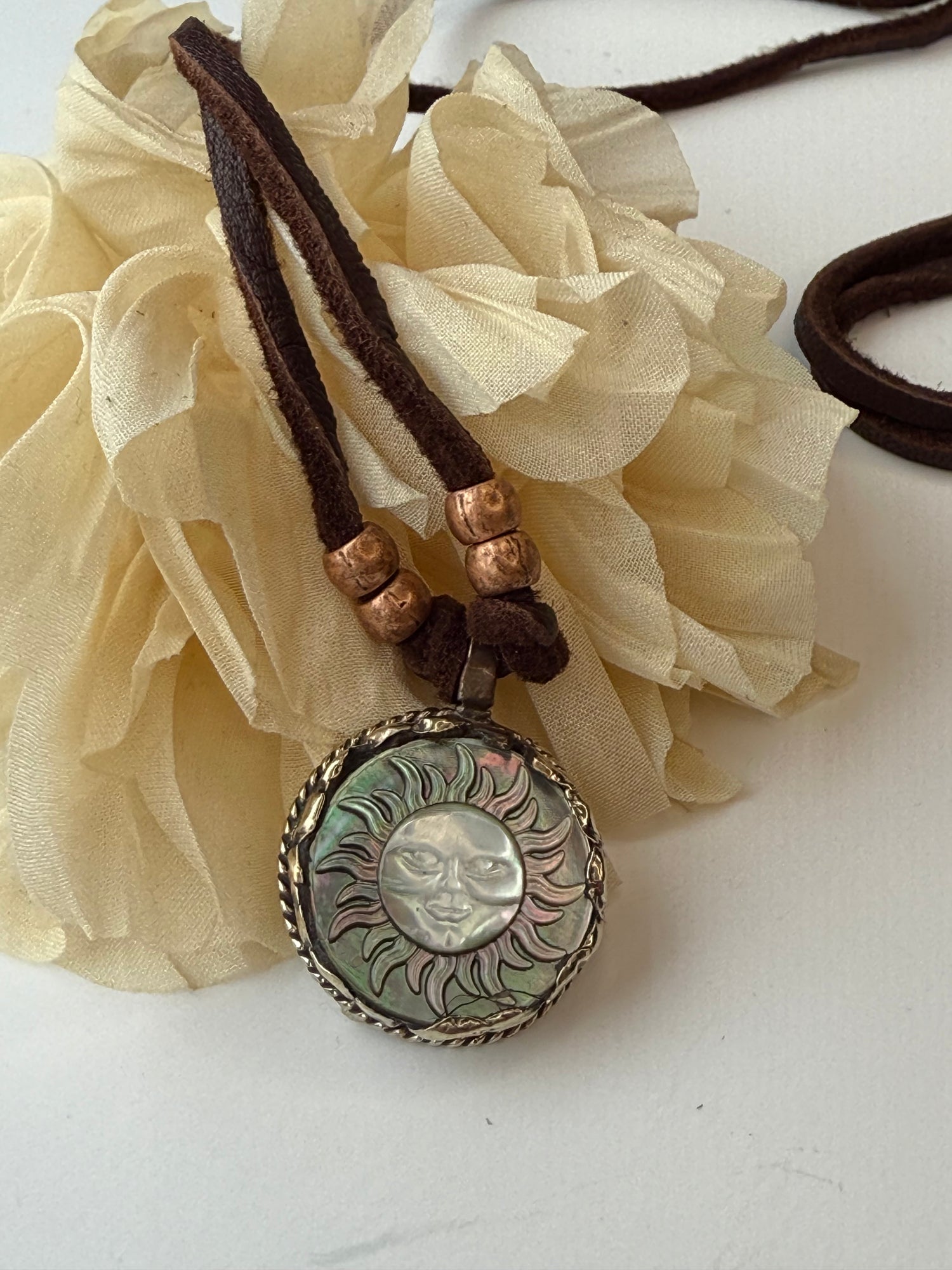 Necklace with decorative pendant on a white background