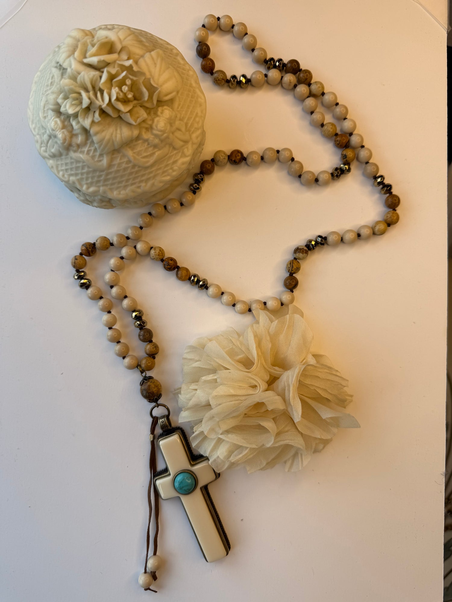 Necklace with bone cross on a white surface