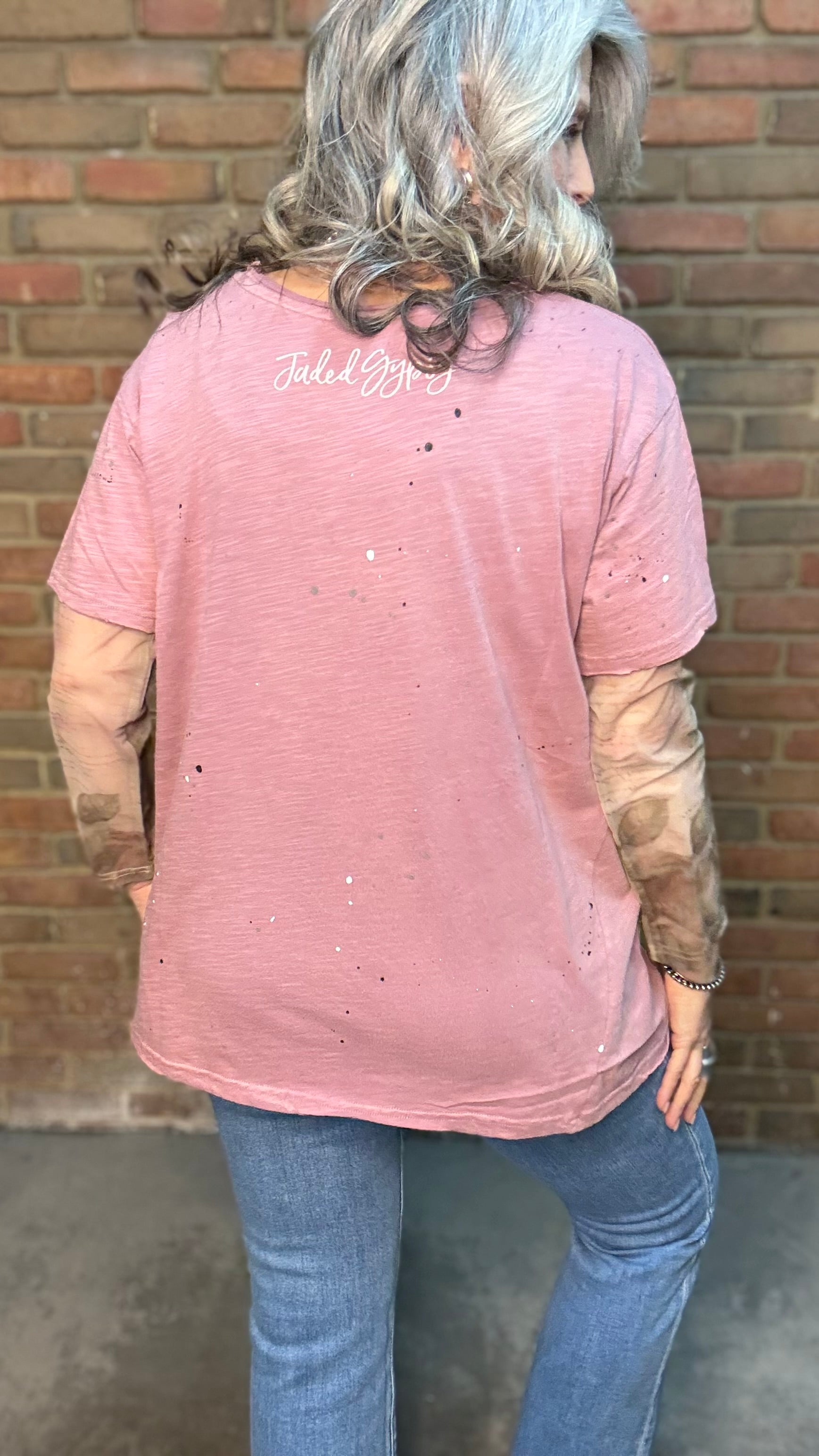 Woman wearing Moon Dance Tee - Cherished Heart tee against brick wall.