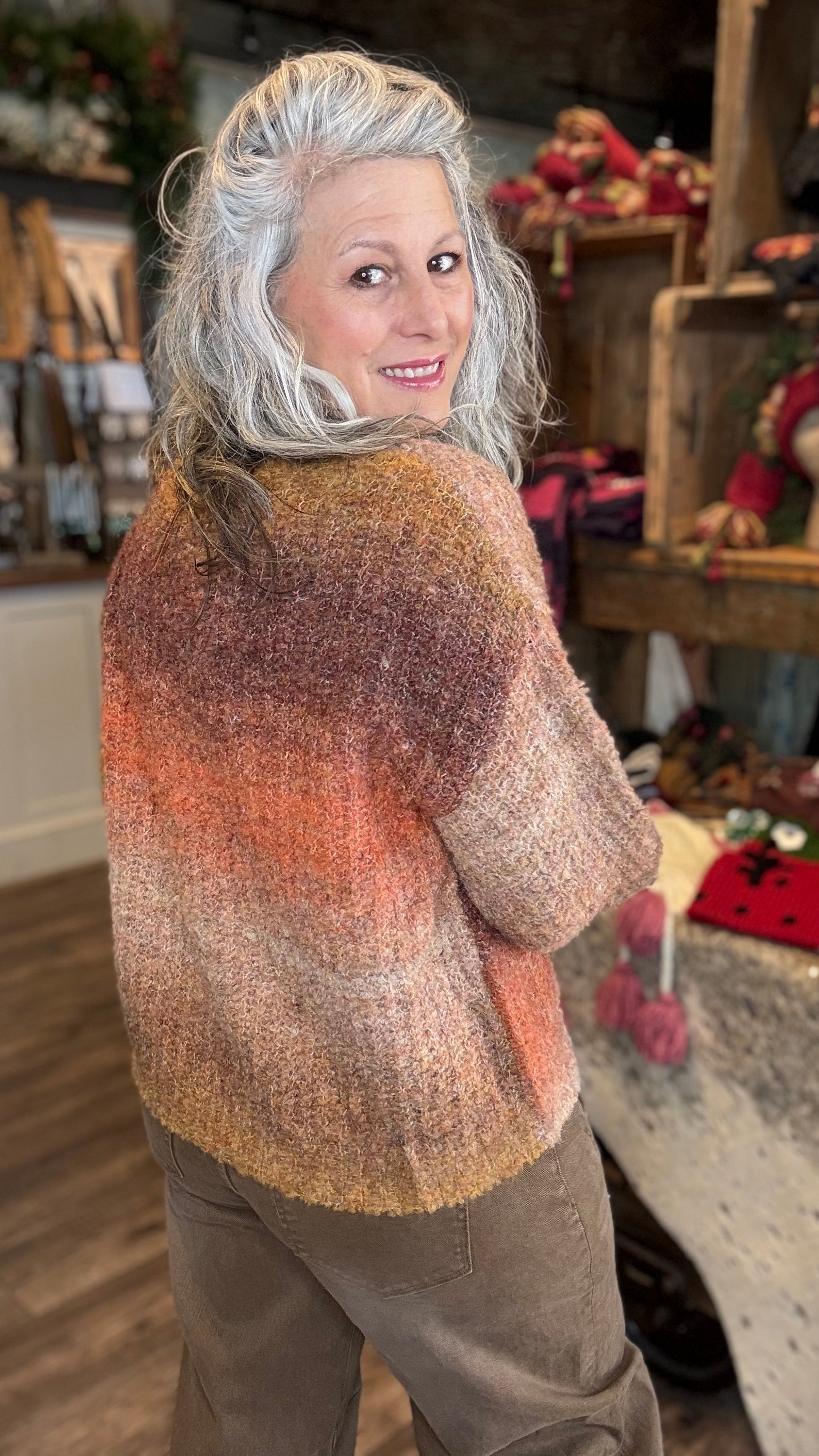 Person wearing a gradient sweater in a store setting