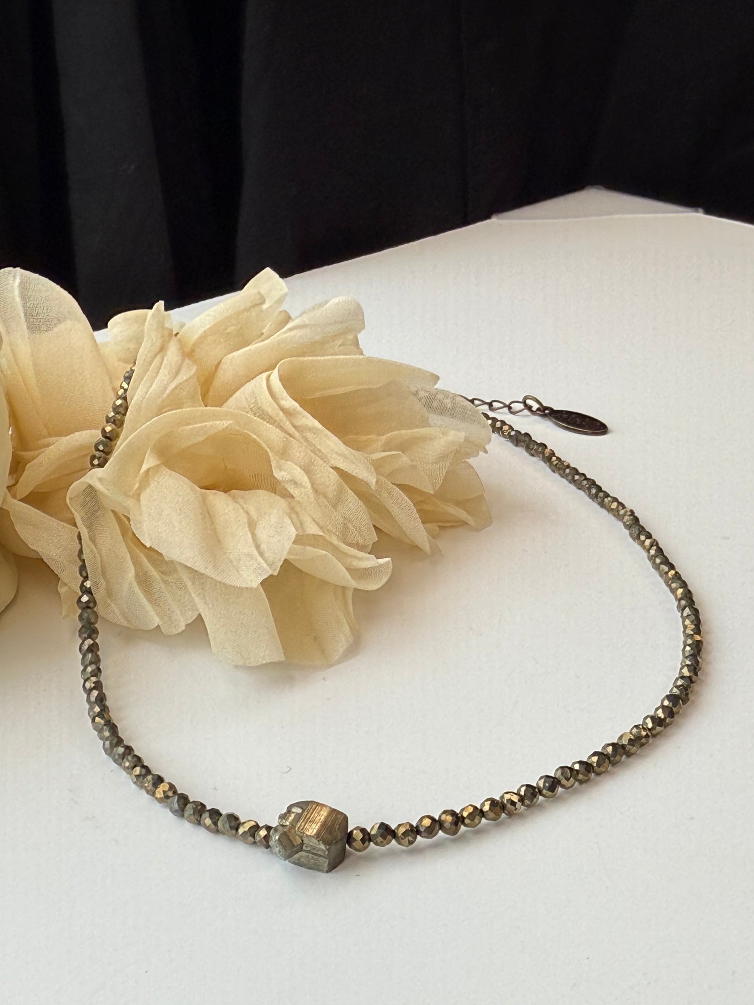 Necklace with nugget pendant on a white surface