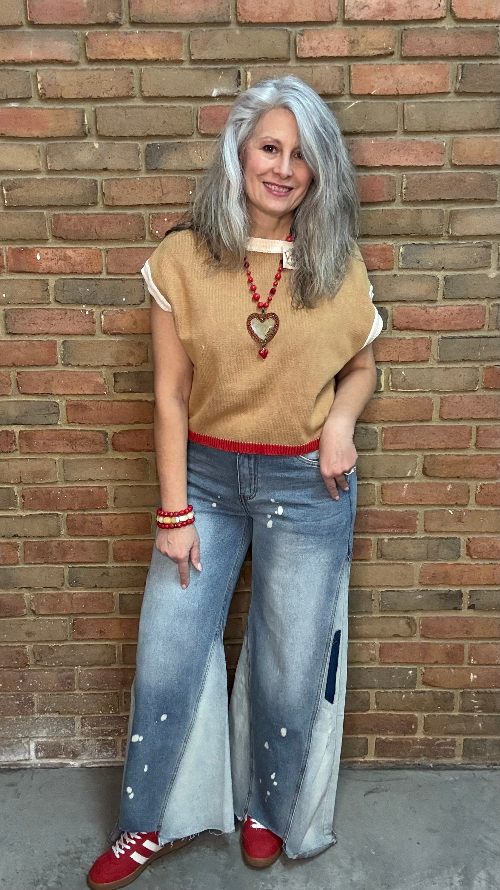 Woman wearing Chestnut Flame Sweater paired with Bleached Wide Leg Jeans and Heads Up - Red Shoes styled with XOXO heart on Red Bead Necklace