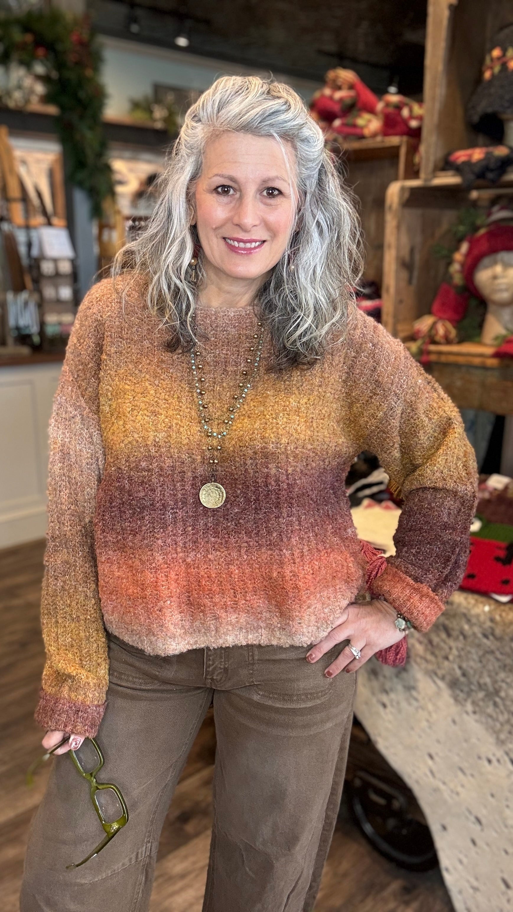 Woman wearing a colorful sweater in a store setting