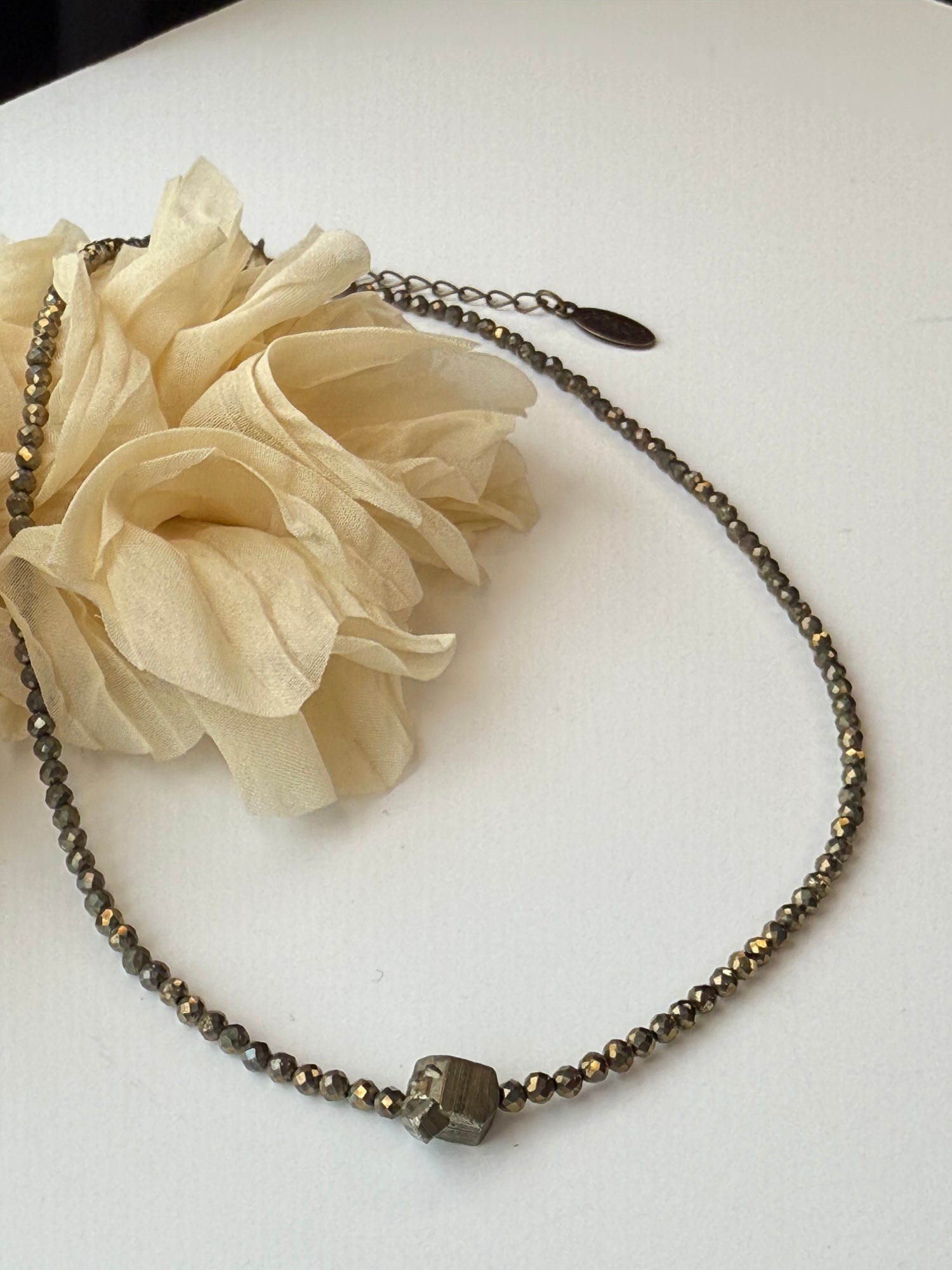 Necklace with beads and a nugget focal on a white background