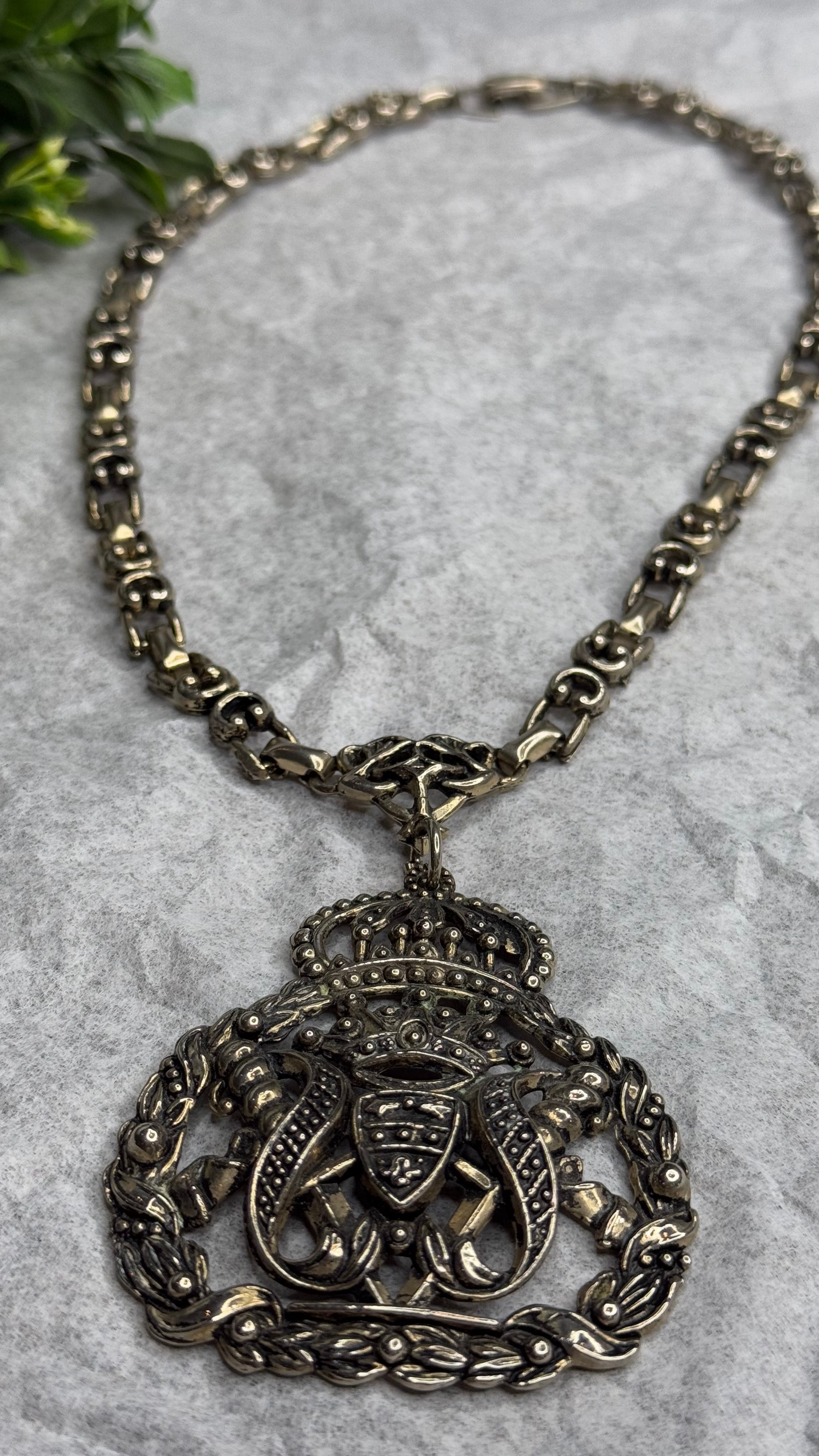 Decorative necklace with intricate design on a textured surface