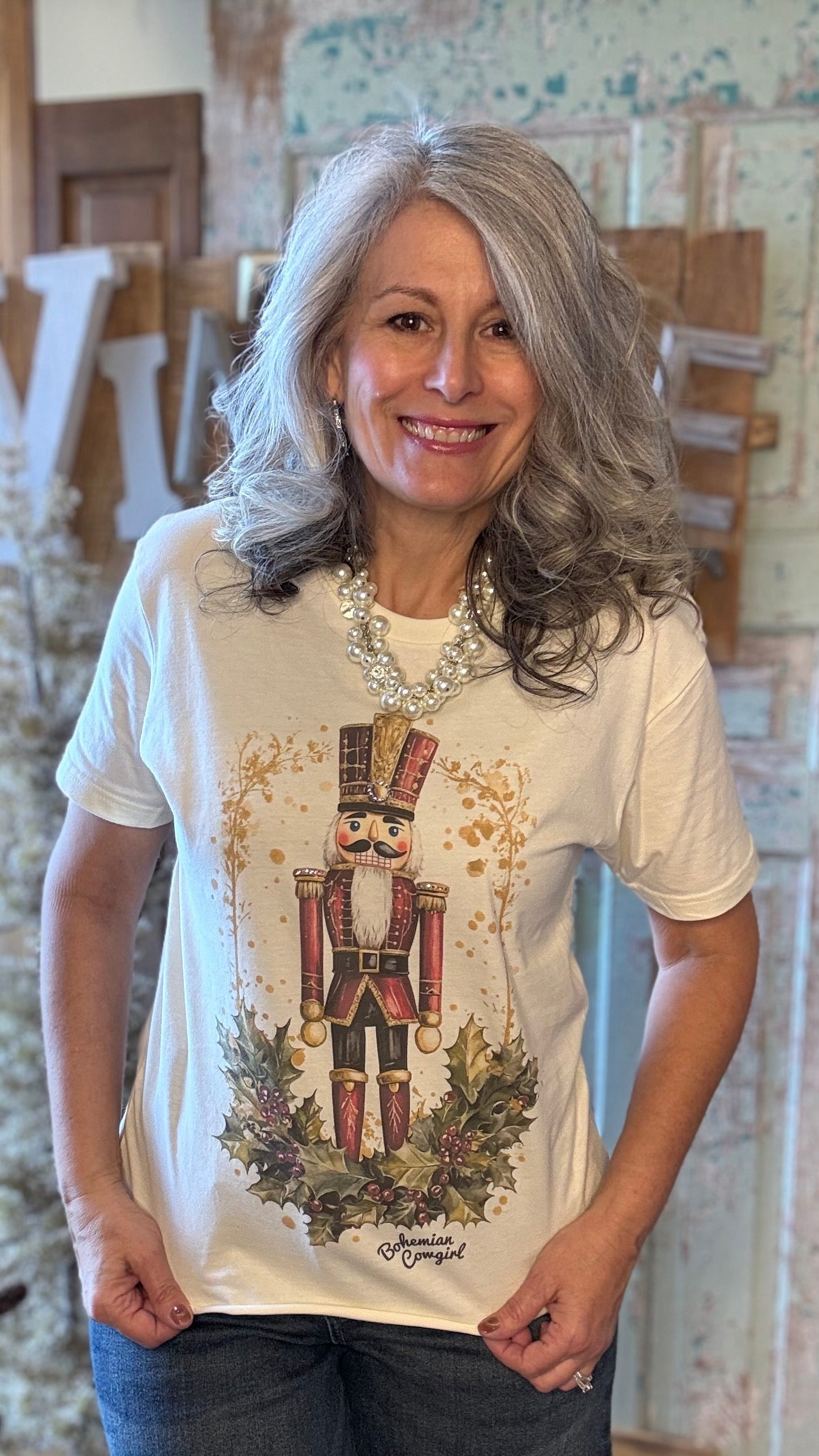 Woman wearing a white t-shirt with a graphic design in a store setting