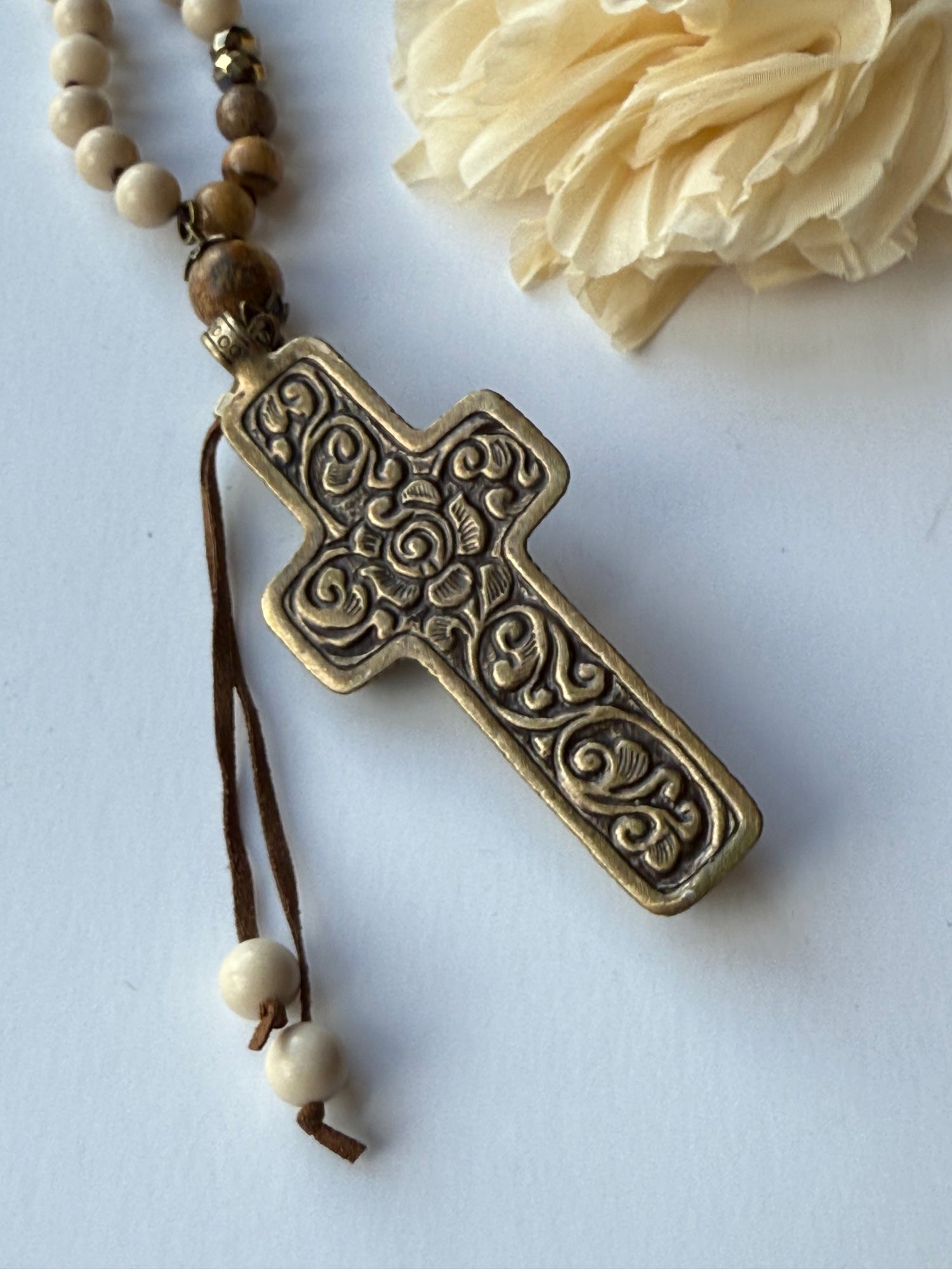 Decorative cross with intricate patterns on a white background