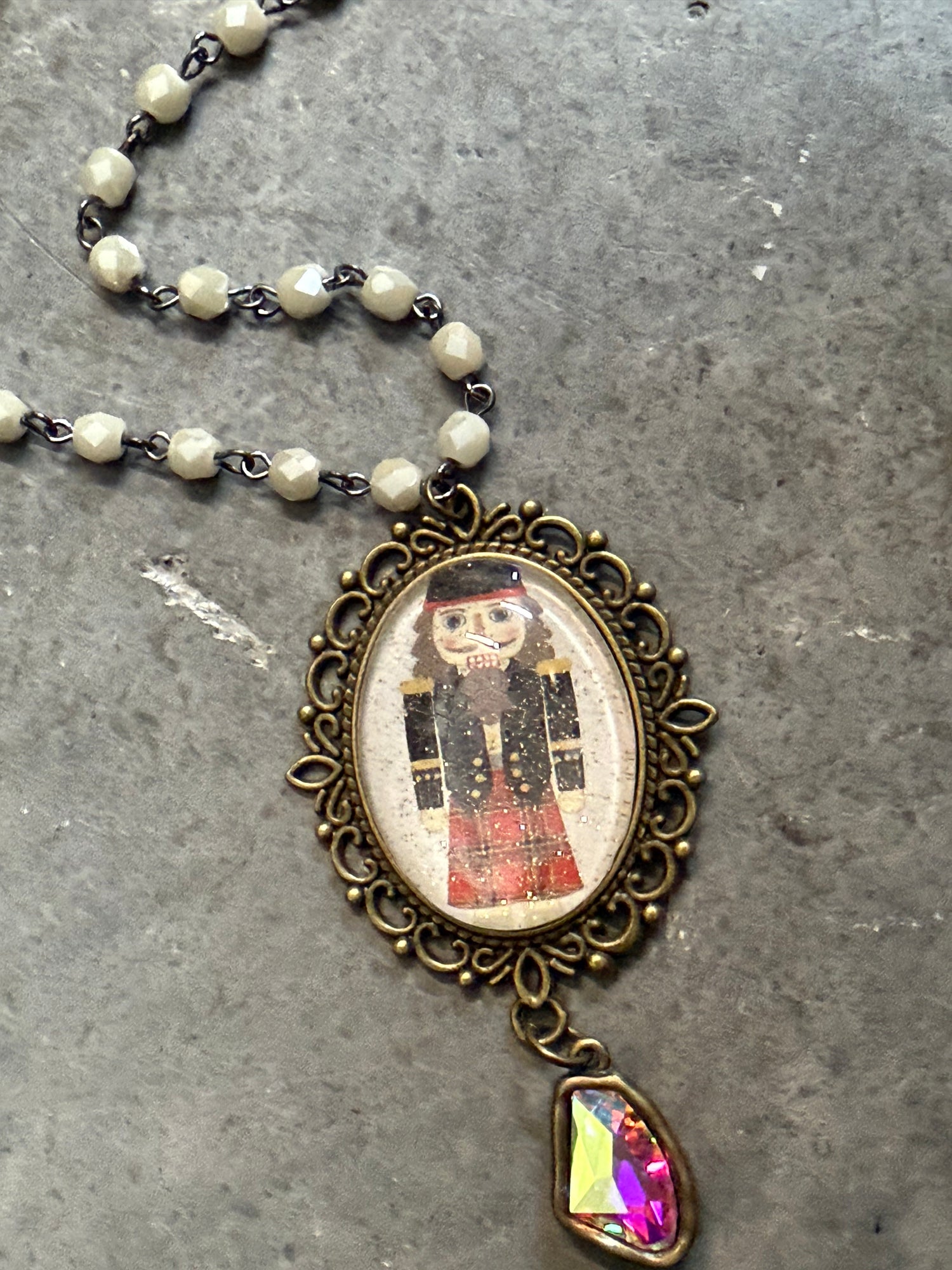 Necklace with a pendant featuring a vintage-style illustration on a textured surface