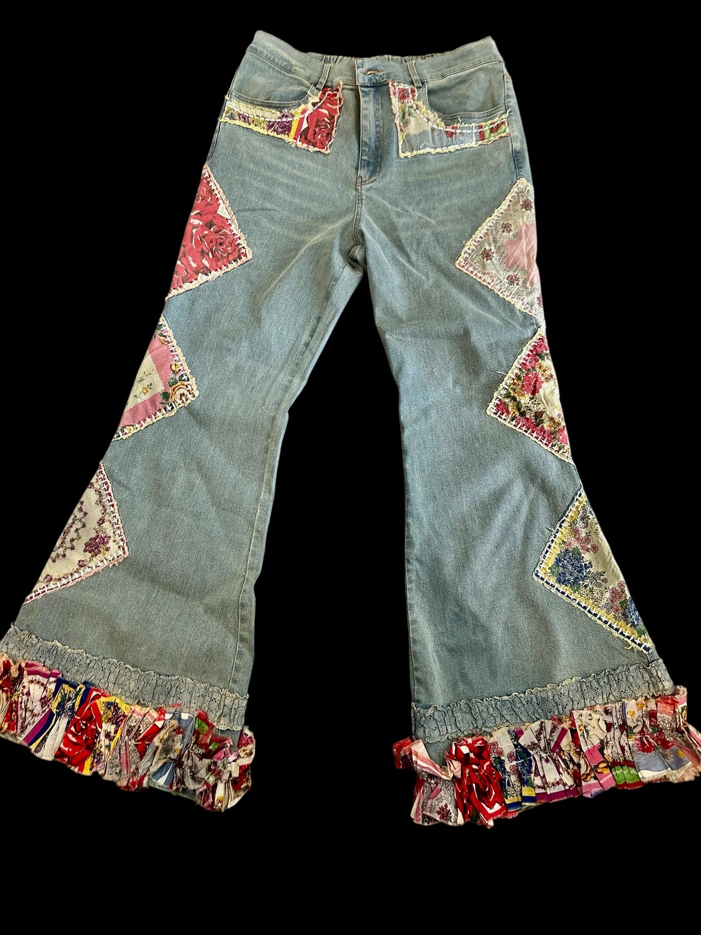 Flared jeans with colorful patchwork details on a black background