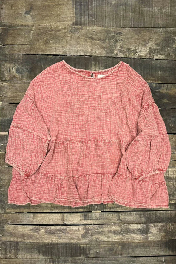 Pink blouse on a wooden background