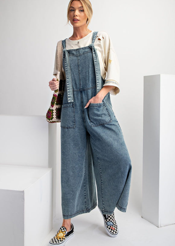 Front view of Wide leg stone washed Denim jumpsuit on model.