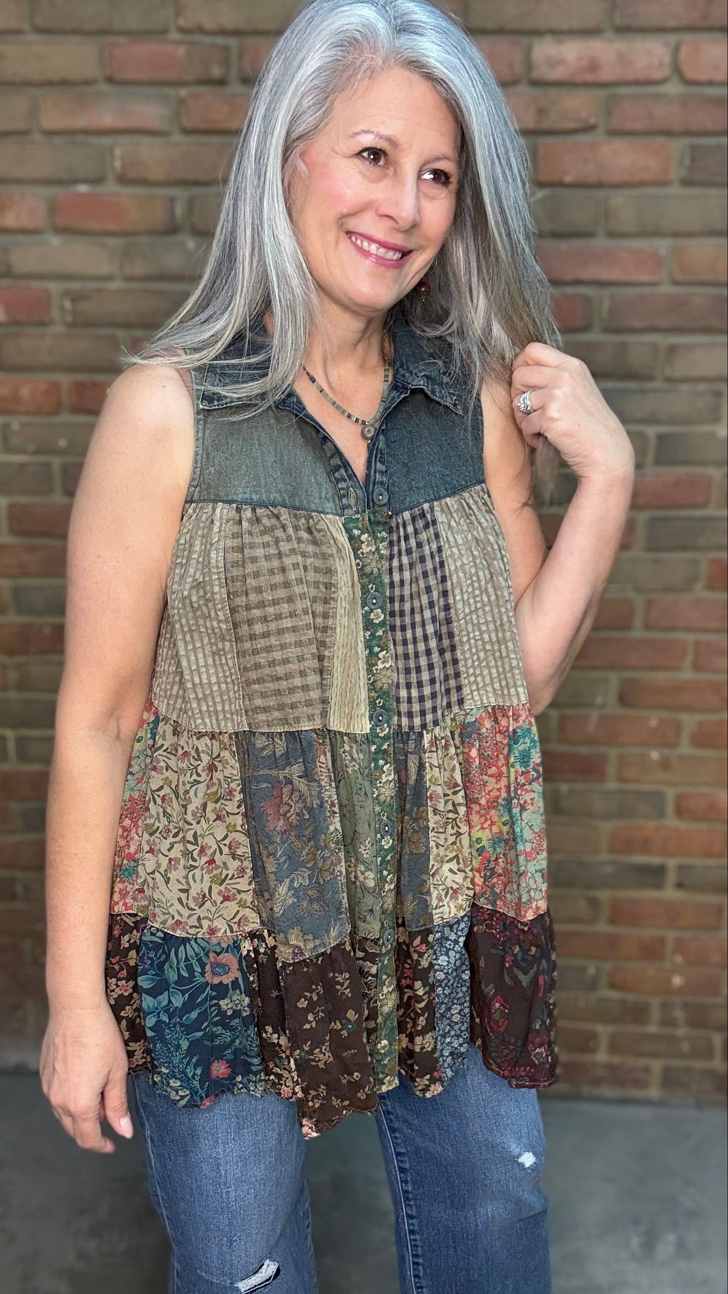 Person wearing a Boho Nomad Patchwork Top in front of a brick wall