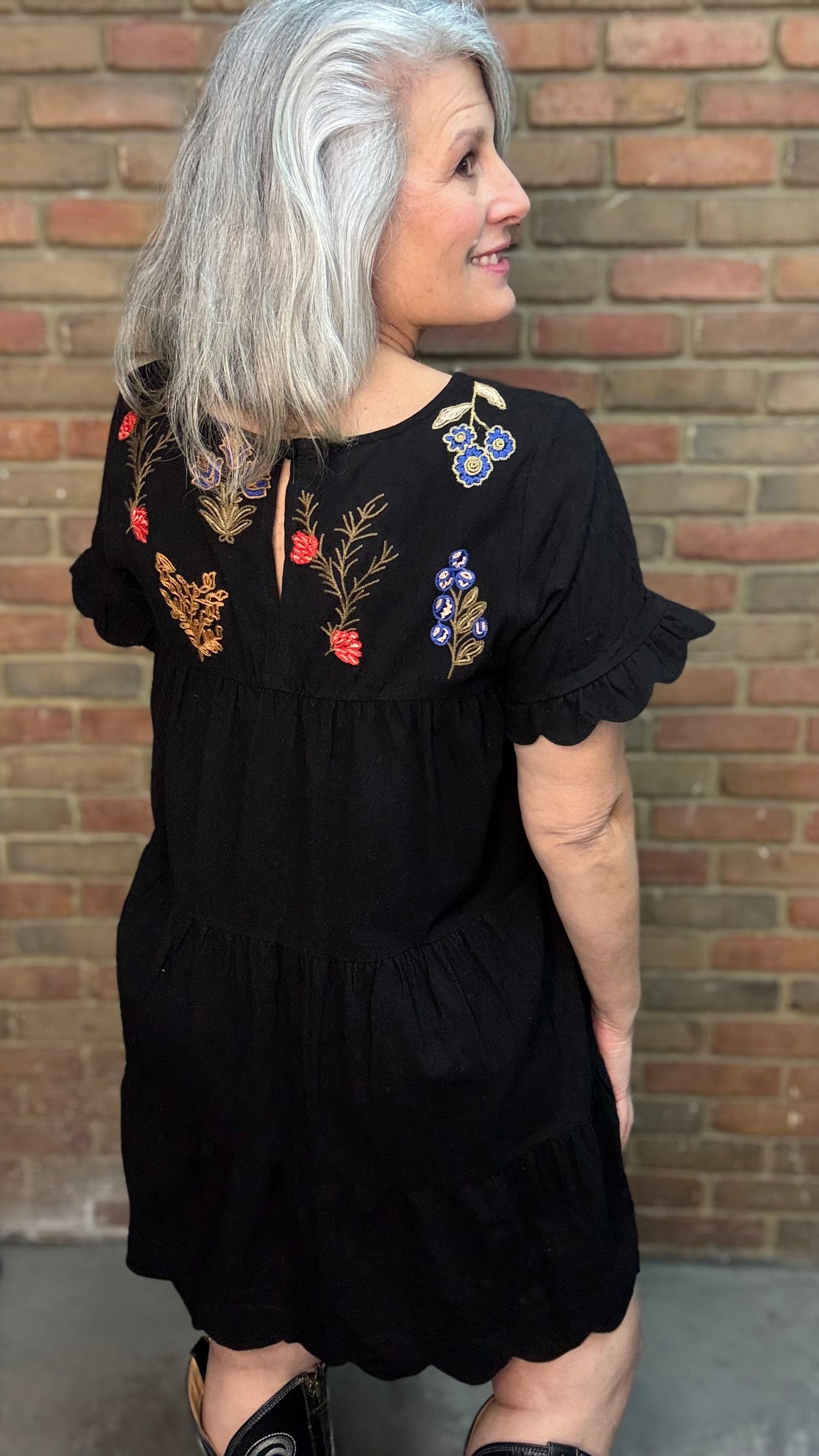 Woman wearing Embroidered Tiered Keyhole Dress paired with Ebony Stitched Western Tall Boots