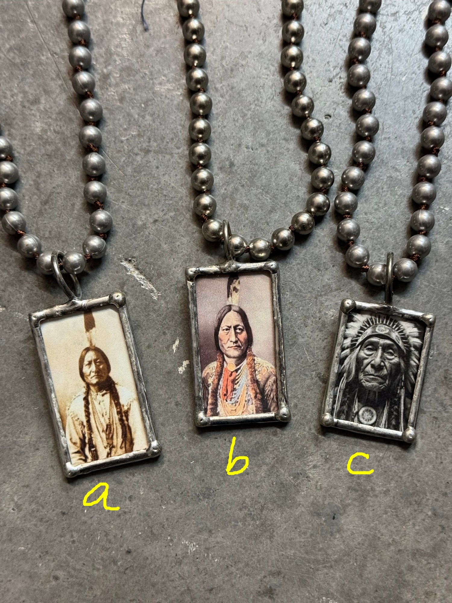 Necklace with rectangular pendants featuring images of a person on a textured surface