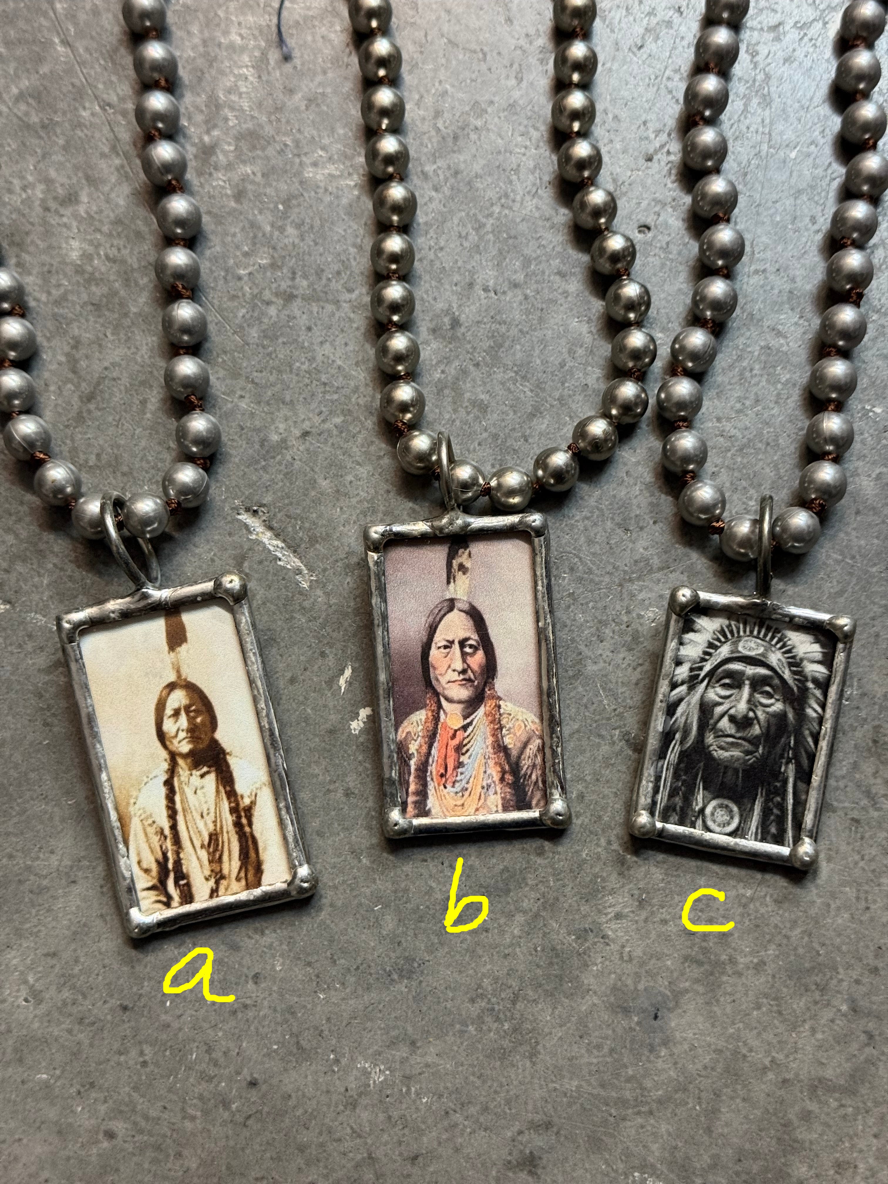 Necklace with rectangular pendants featuring images of a person on a textured surface