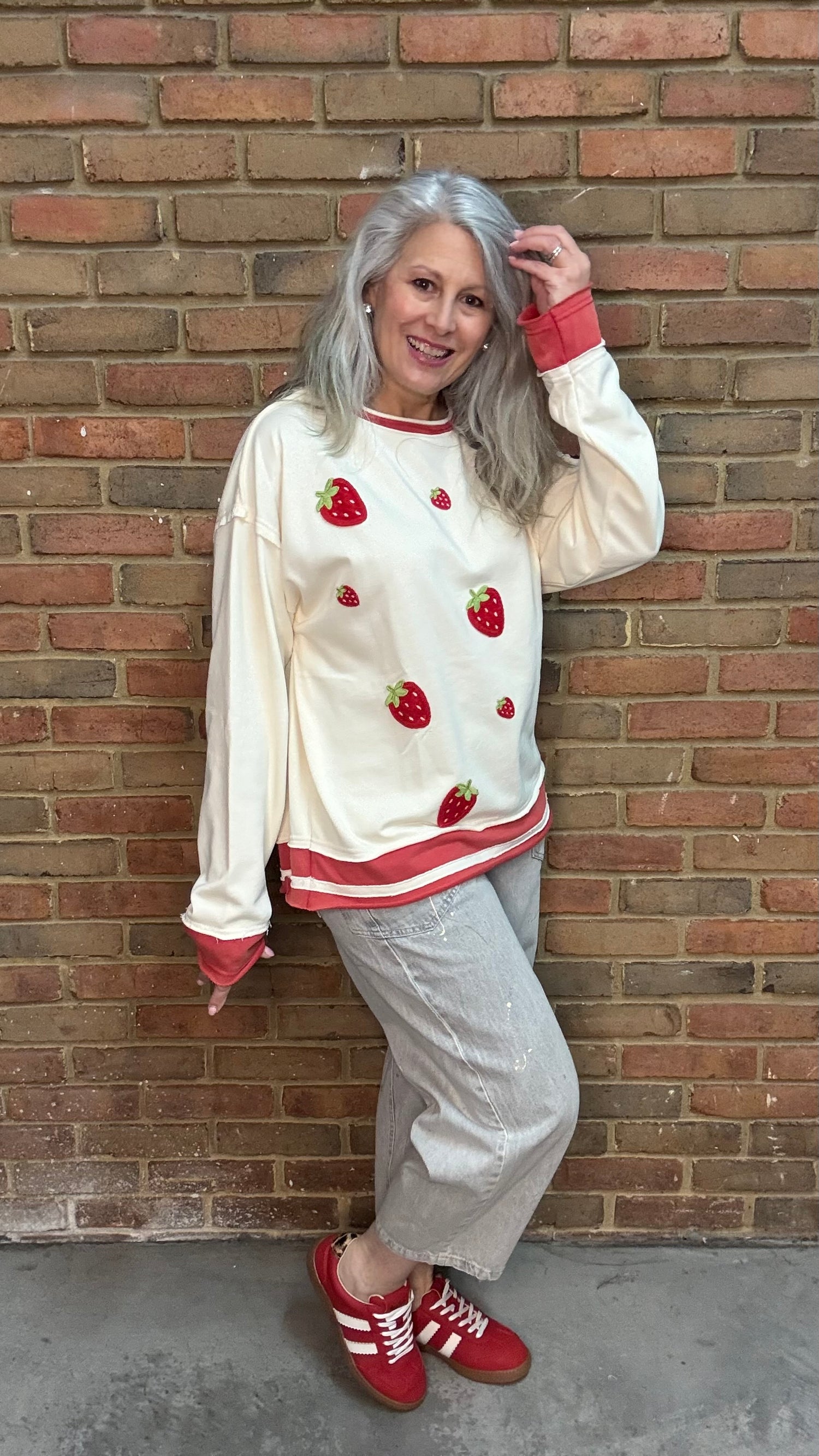 Woman wearing Strawberry Sweatshirt with Oyster Grey Big Pocket Jeans and Heads Up - Red Shoes