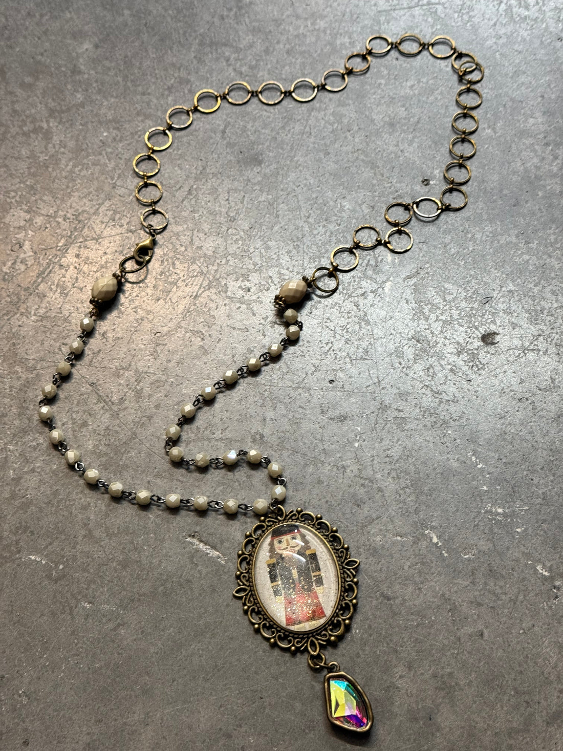 Necklace with a vintage-style pendant on a textured gray surface