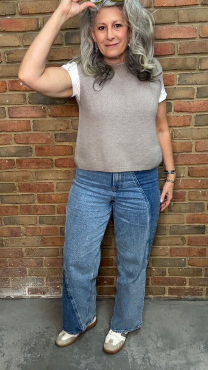 Woman in the HOLLY Super High Rise Two Tone Straight Jean casual outfit standing against a brick wall