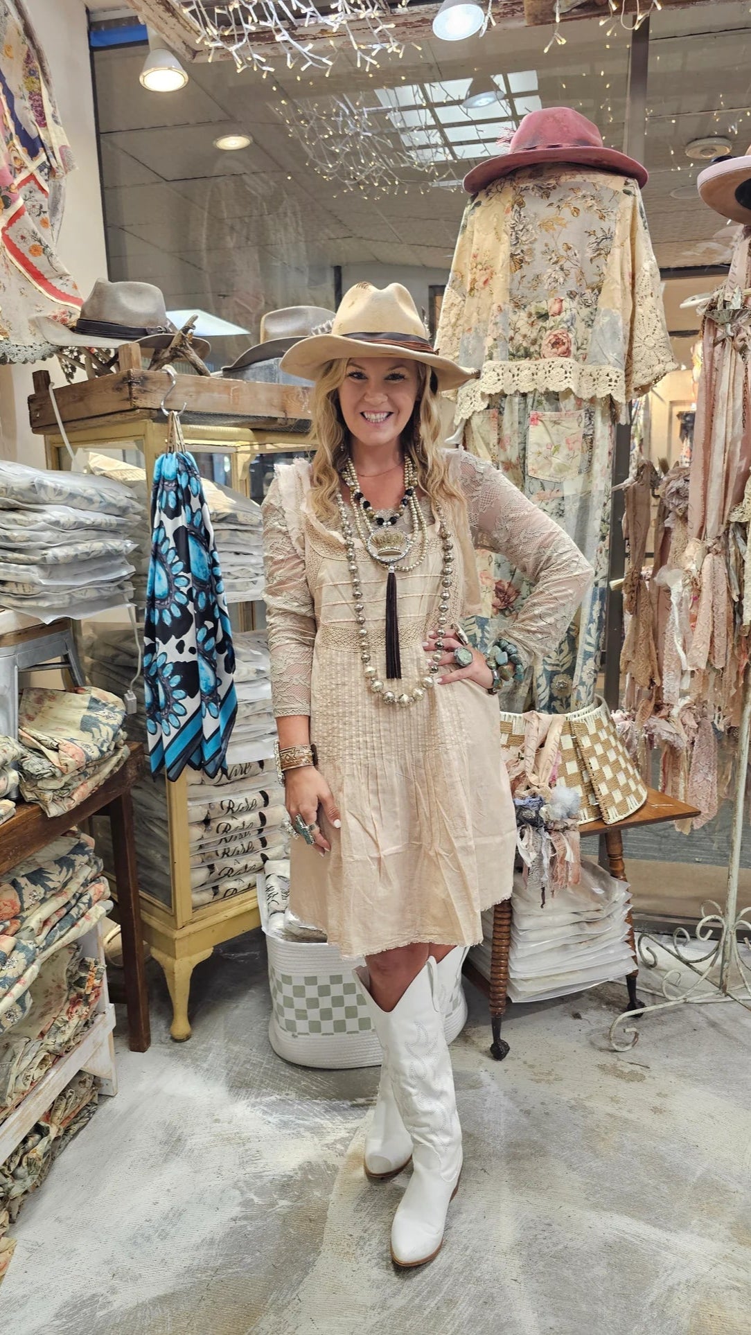 Woman in a store with fabric and hat displays