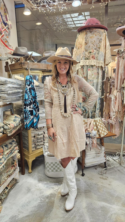 Woman in a store with fabric and hat displays