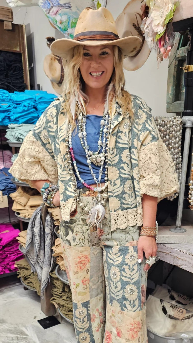 Woman in a bohemian outfit with a hat in a store setting