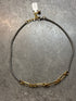 Gold and silver chain necklace on a gray surface