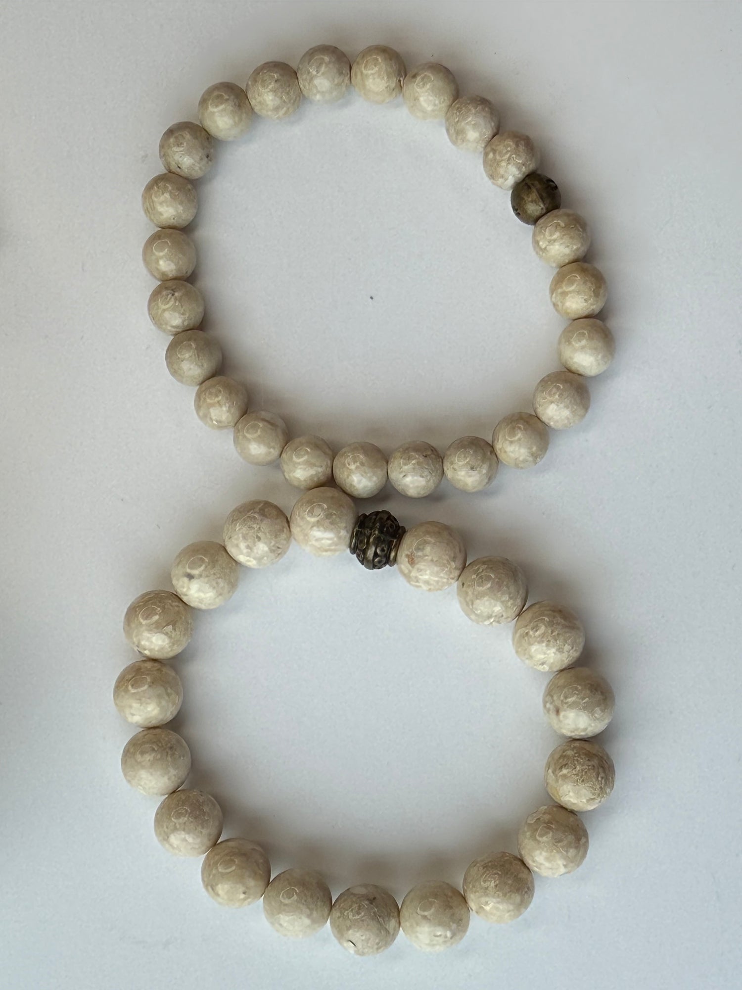 Two stone beaded bracelets on a white background