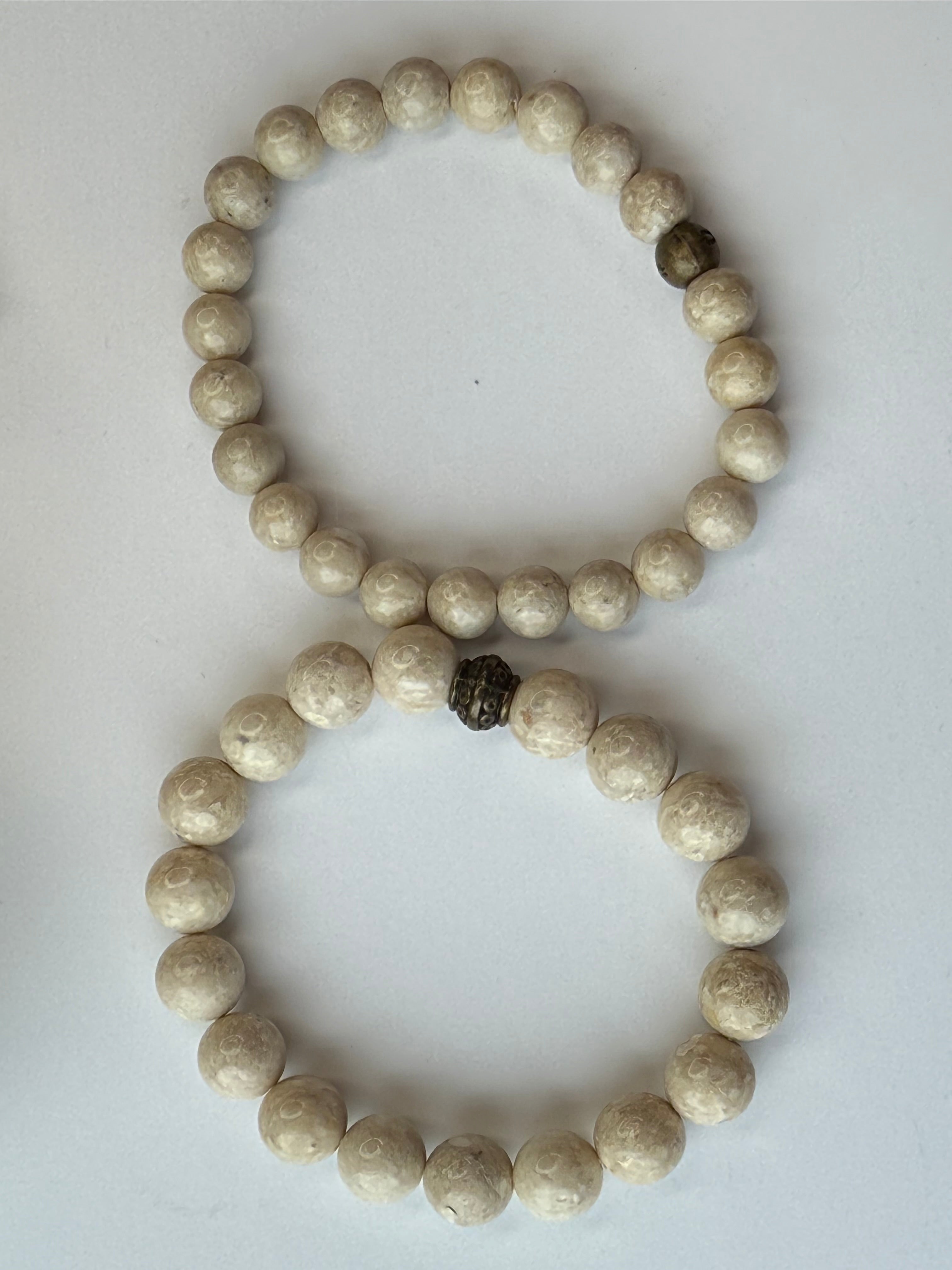 Two stone beaded bracelets on a white background