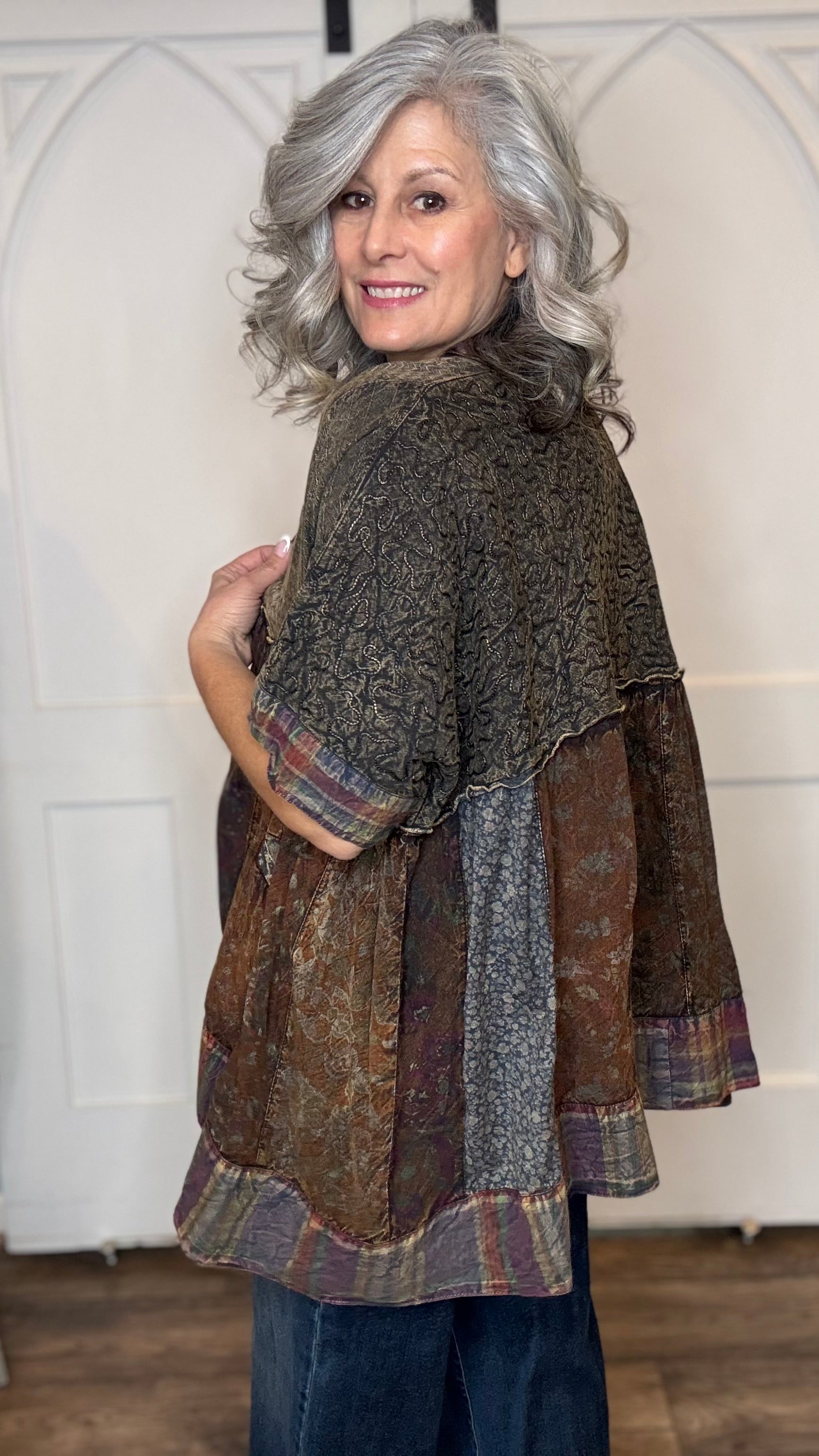 Woman wearing Boho Kimono Shrug Cardigan over a Moon Dance V-Neck in Olive and Judy Blue Palazzo Patch Pocket jeans in front of a white door.