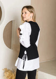 Back angle view of Wanelle Top with Ruffled Sleeves and detachable Knitted Sweater Vest on a model.
