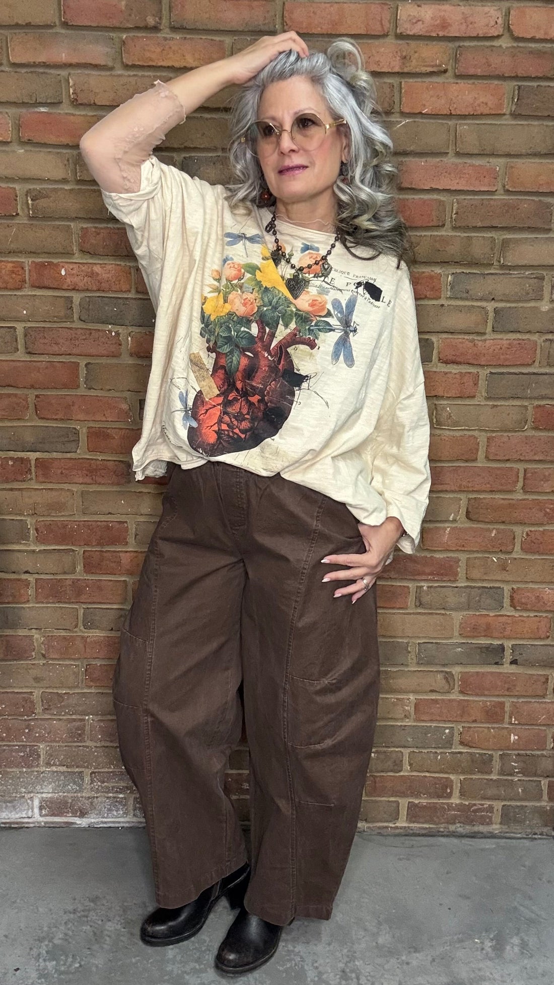 Person wearing Be Free Top - Growth and the Brown Pull On Barrel pants standing against a brick wall.