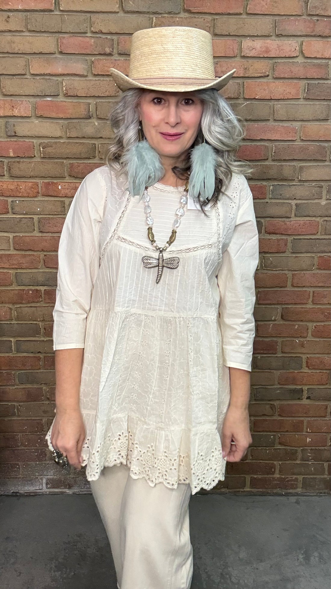 Woman wearing a Dragonfly Pendant on Pearl Necklace.