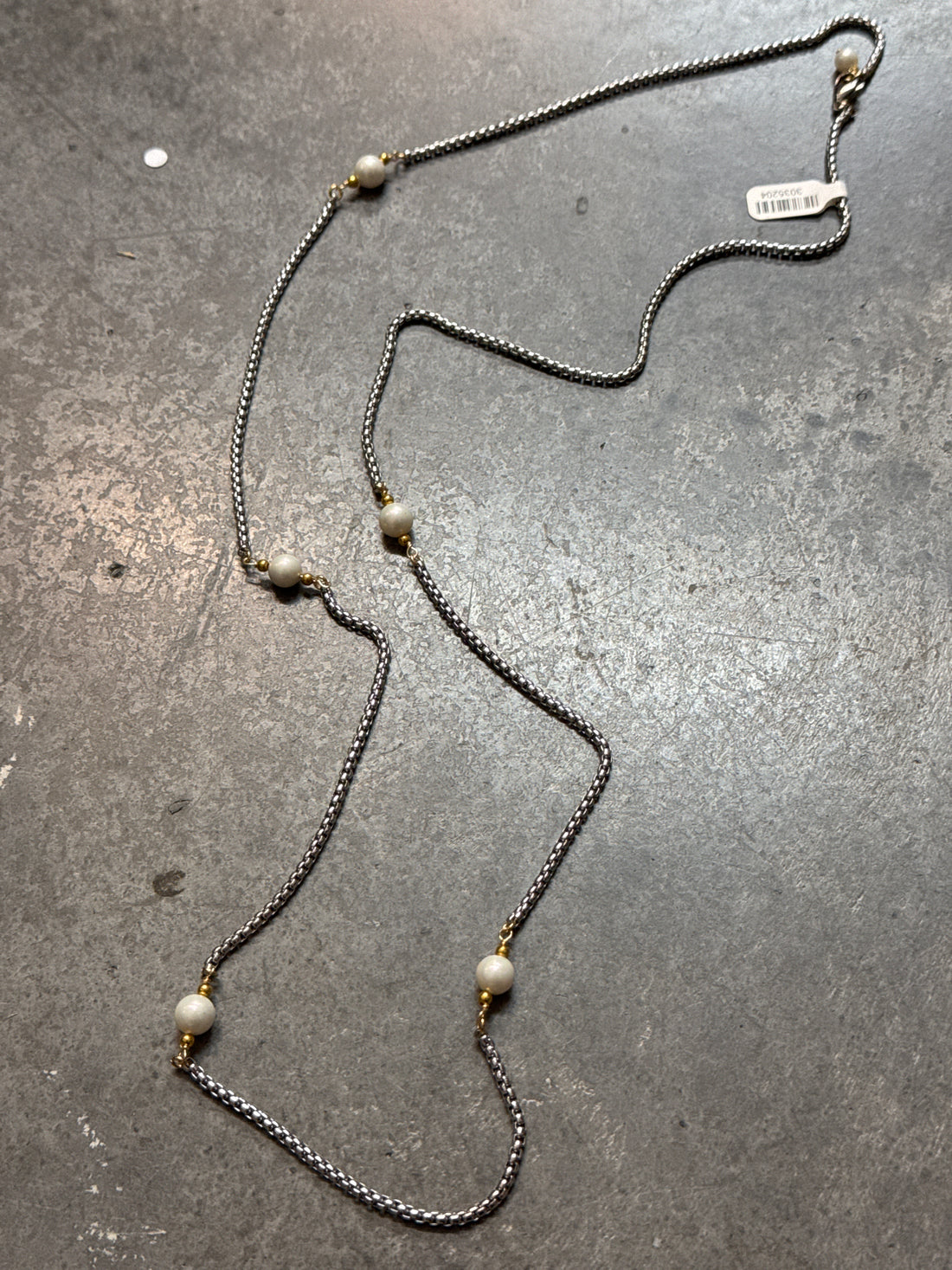 Necklace with pearls on a gray surface