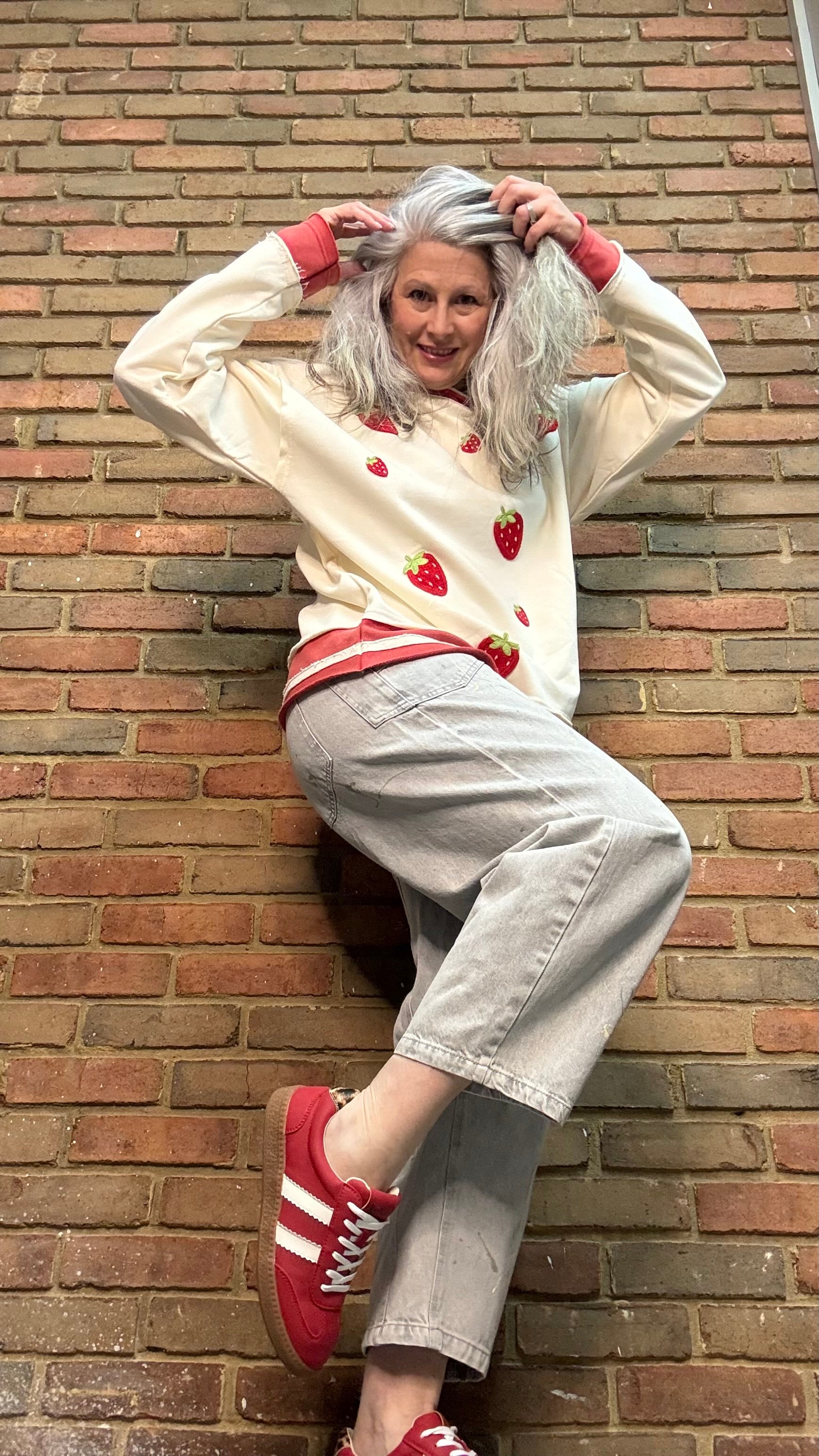 Woman wearing Strawberry Sweatshirt with Oyster Grey Big Pocket Jeans and Heads Up - Red Shoes
