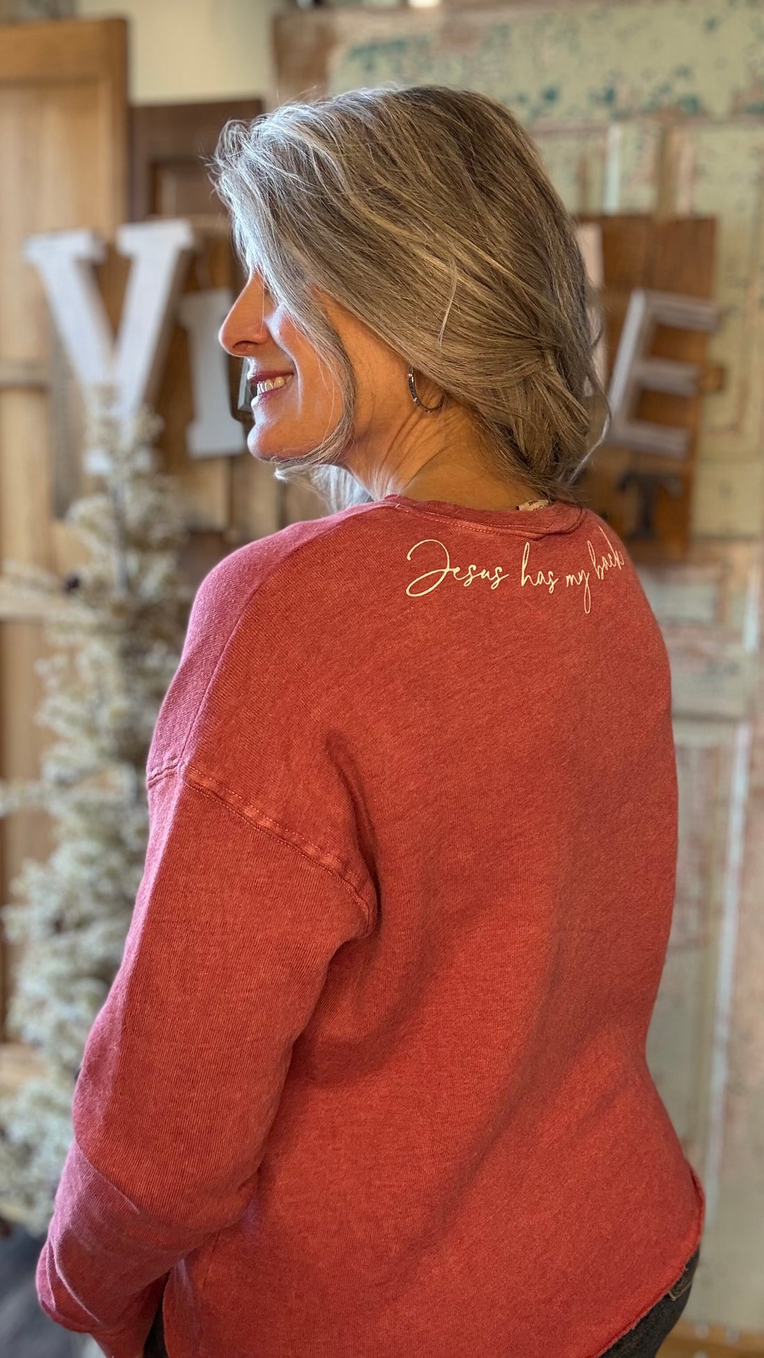 Woman wearing a red shirt with &