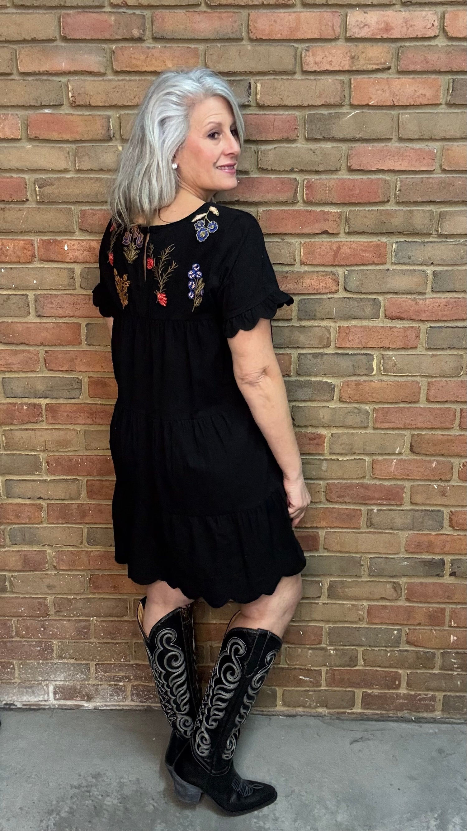 Woman wearing Embroidered Tiered Keyhole Dress paired with Ebony Stitched Western Tall Boots