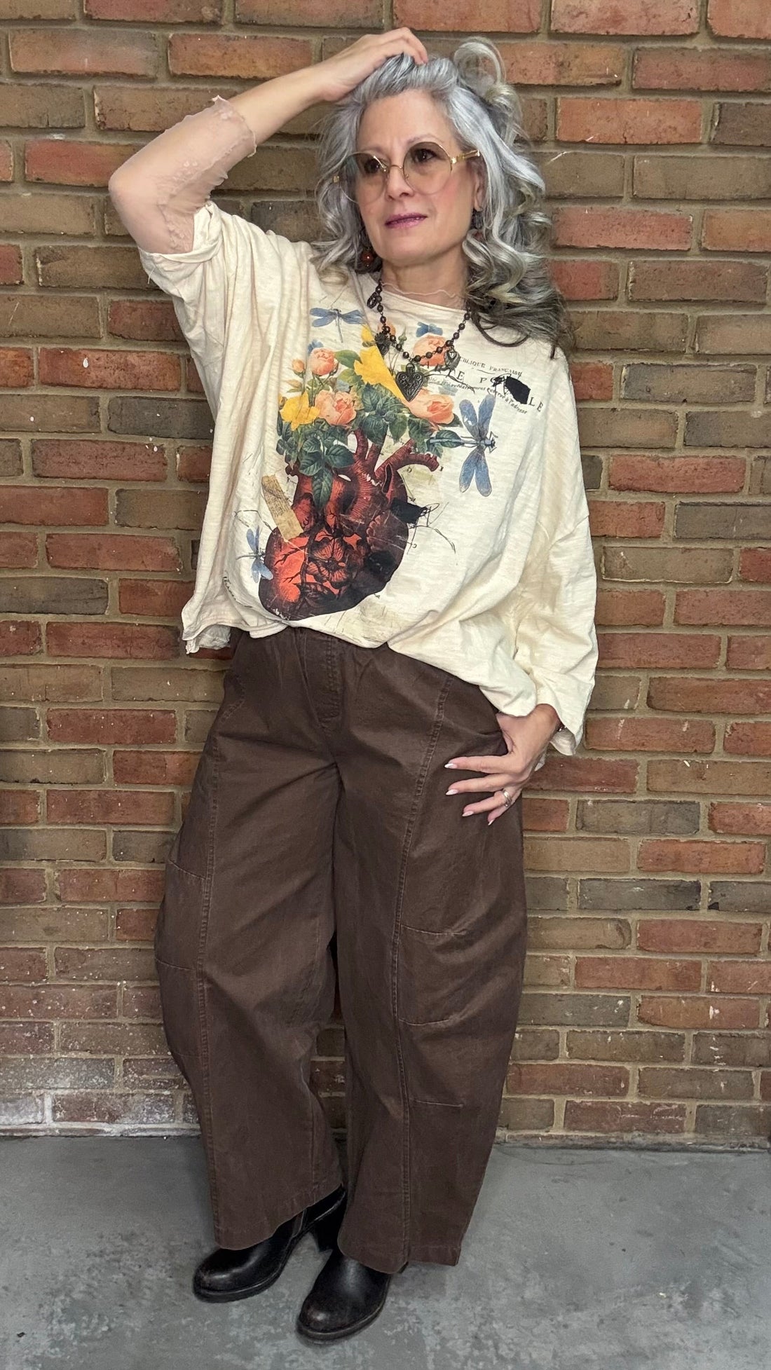 Person wearing a floral heart Be Free Top - Growth, and the Brown Pull On Barrel Pants.