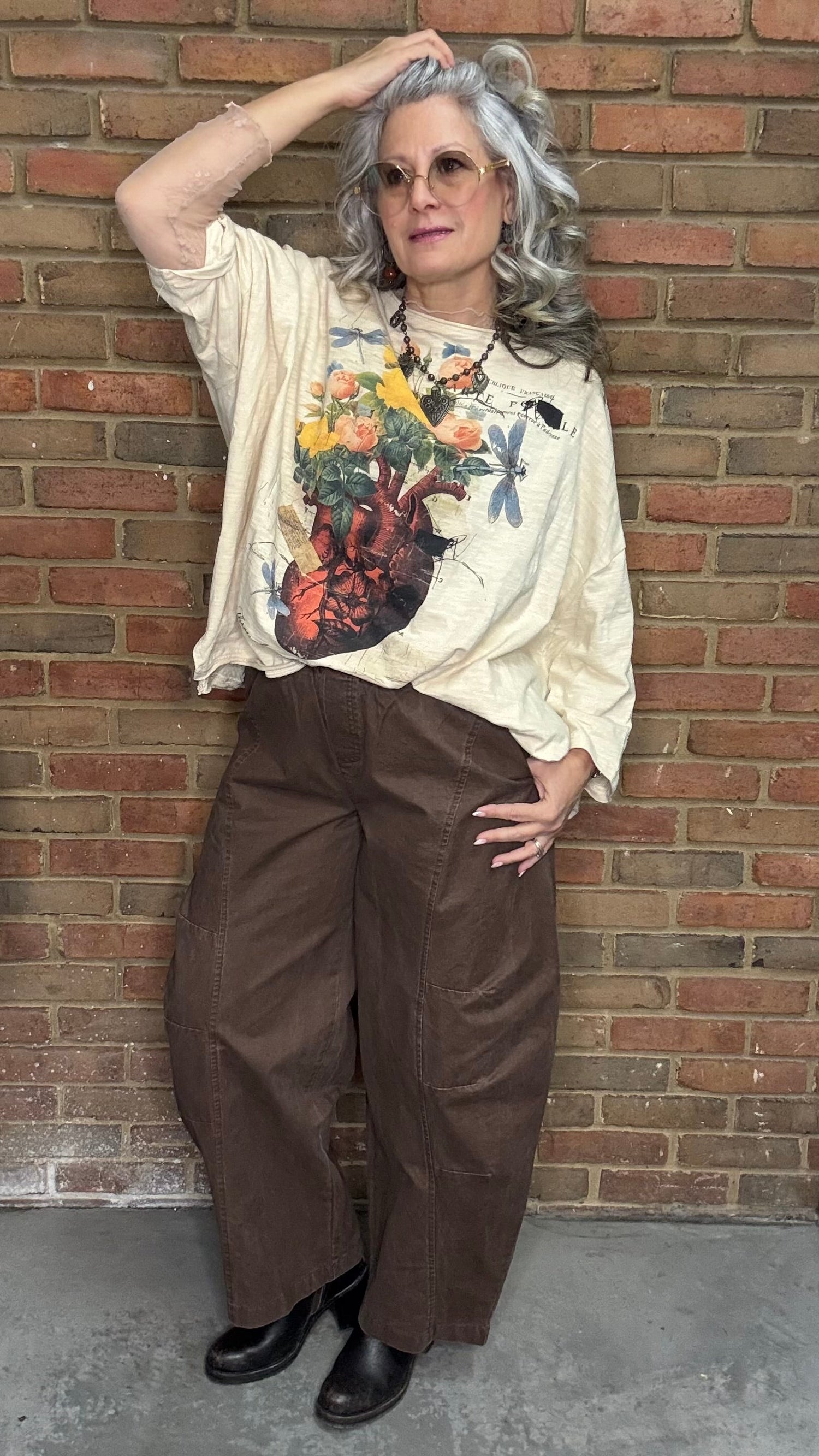 Person wearing a floral heart Be Free Top - Growth, and the Brown Pull On Barrel Pants.