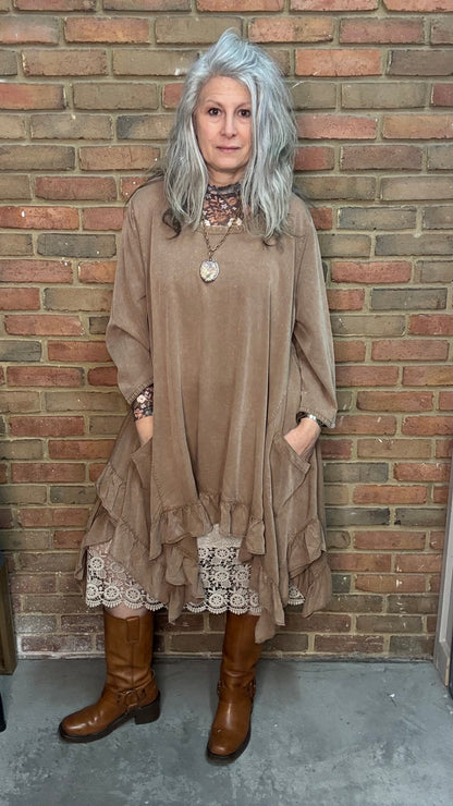 Woman wearing Tan Round Neck Ruffle Top/dress with a mesh top, slip, and Frye Boots.