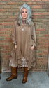 Woman wearing Tan Round Neck Ruffle Top/dress with a mesh top, slip, and Frye Boots.