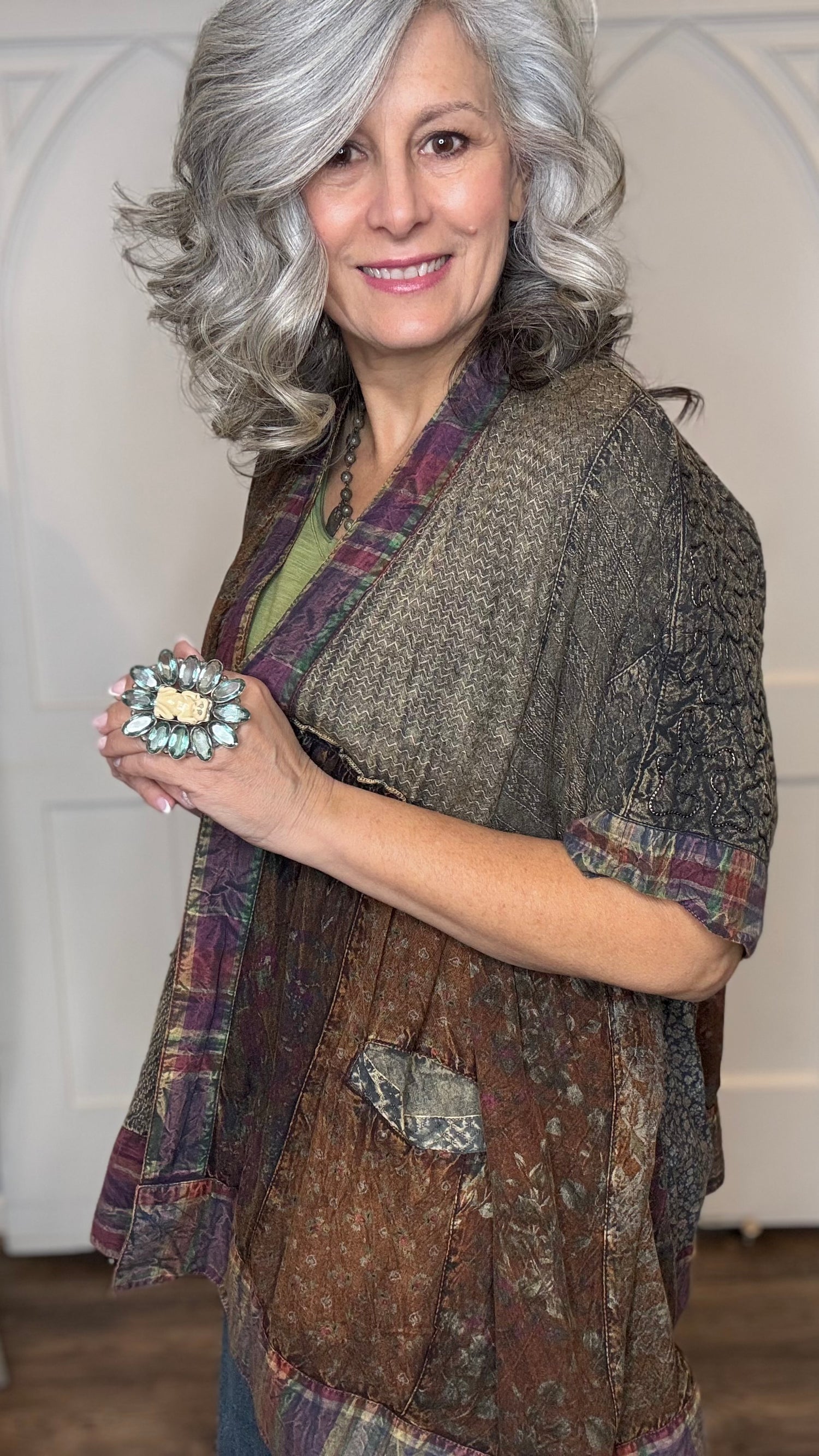 Woman wearing Boho Kimono Shrug Cardigan over a Moon Dance V-Neck in Olive and Judy Blue Palazzo Patch Pocket jeans in front of a white door.