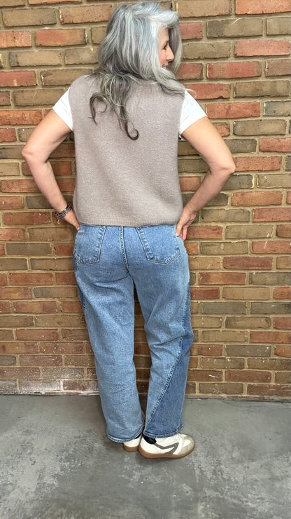 Woman in the HOLLY Super High Rise Two Tone Straight Jean casual outfit standing against a brick wall