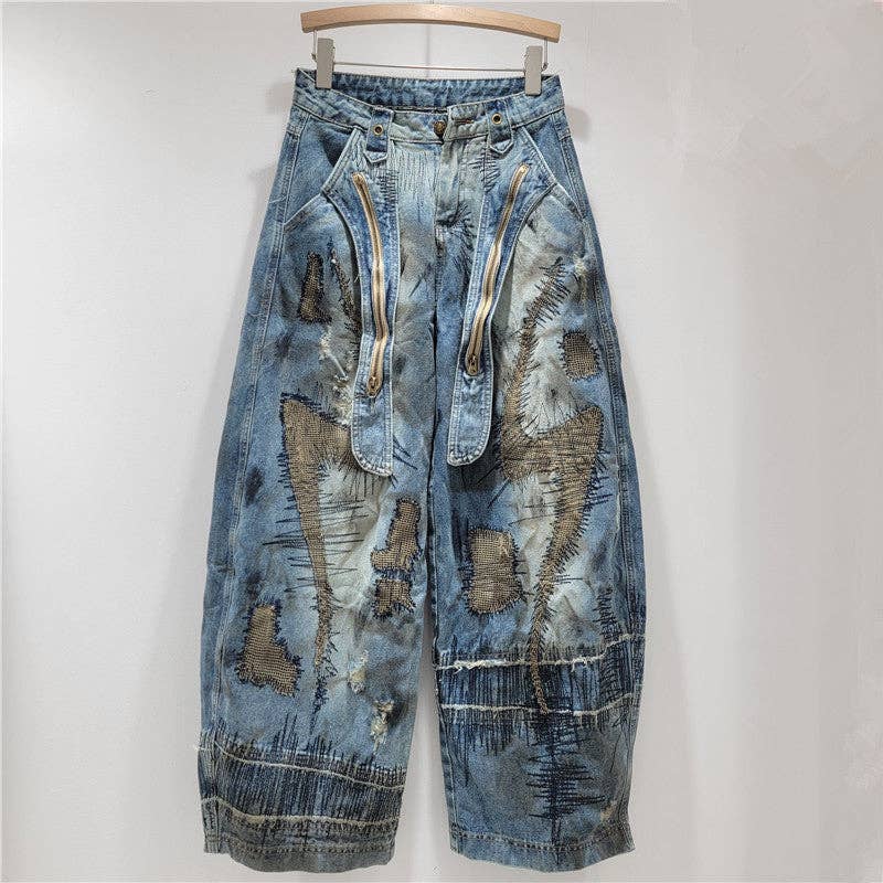 Distressed blue jeans with zippers on a white background