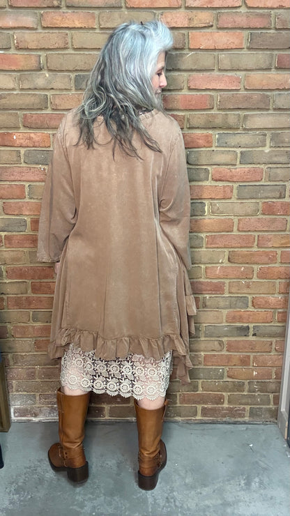 Woman wearing Tan Round Neck Ruffle Top/dress with a mesh top, slip, and Frye Boots.