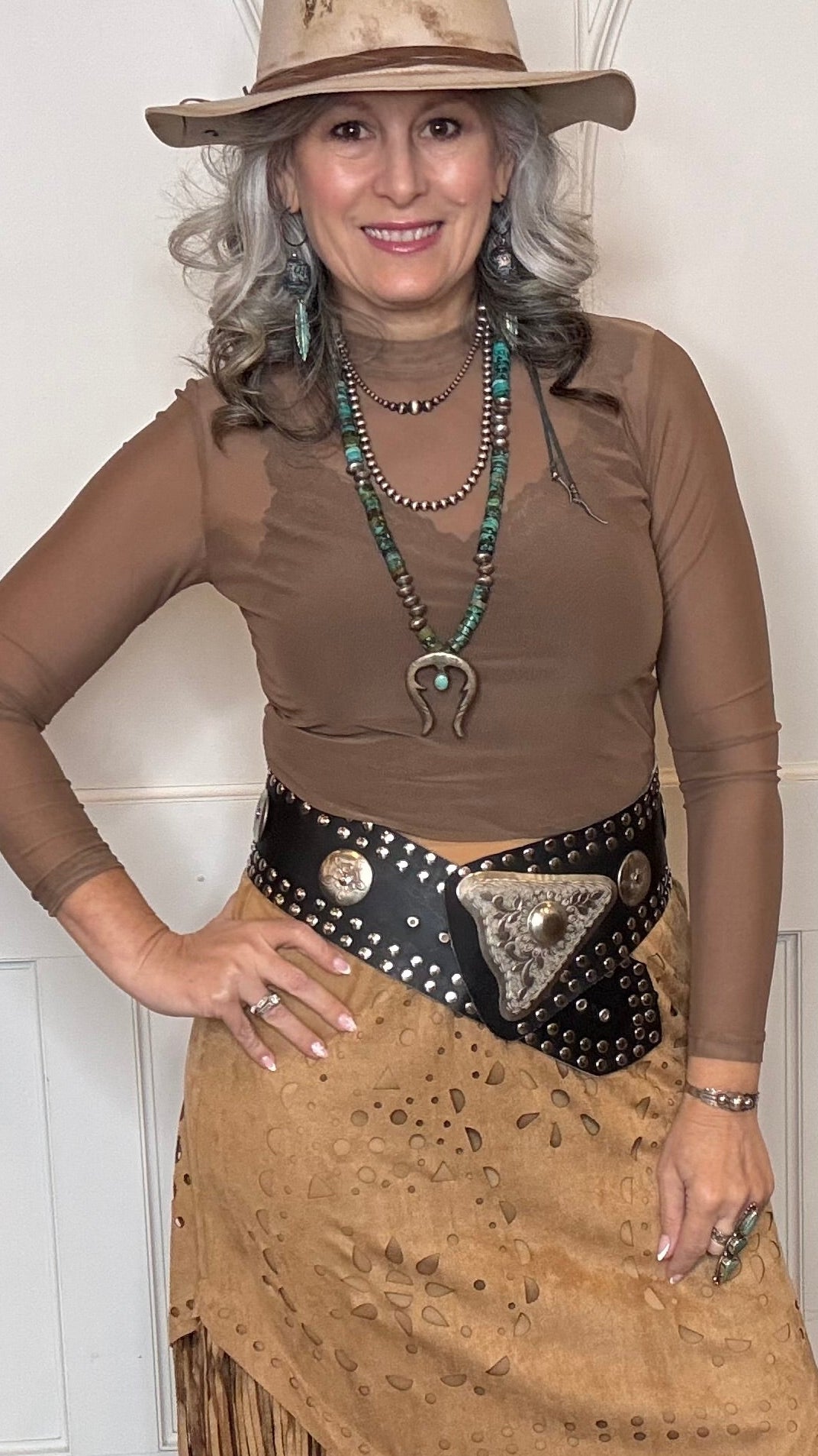 Woman wearing the Wide Triangle Buckle Belt in black with Camel Faux Suede Fringe Skirt.