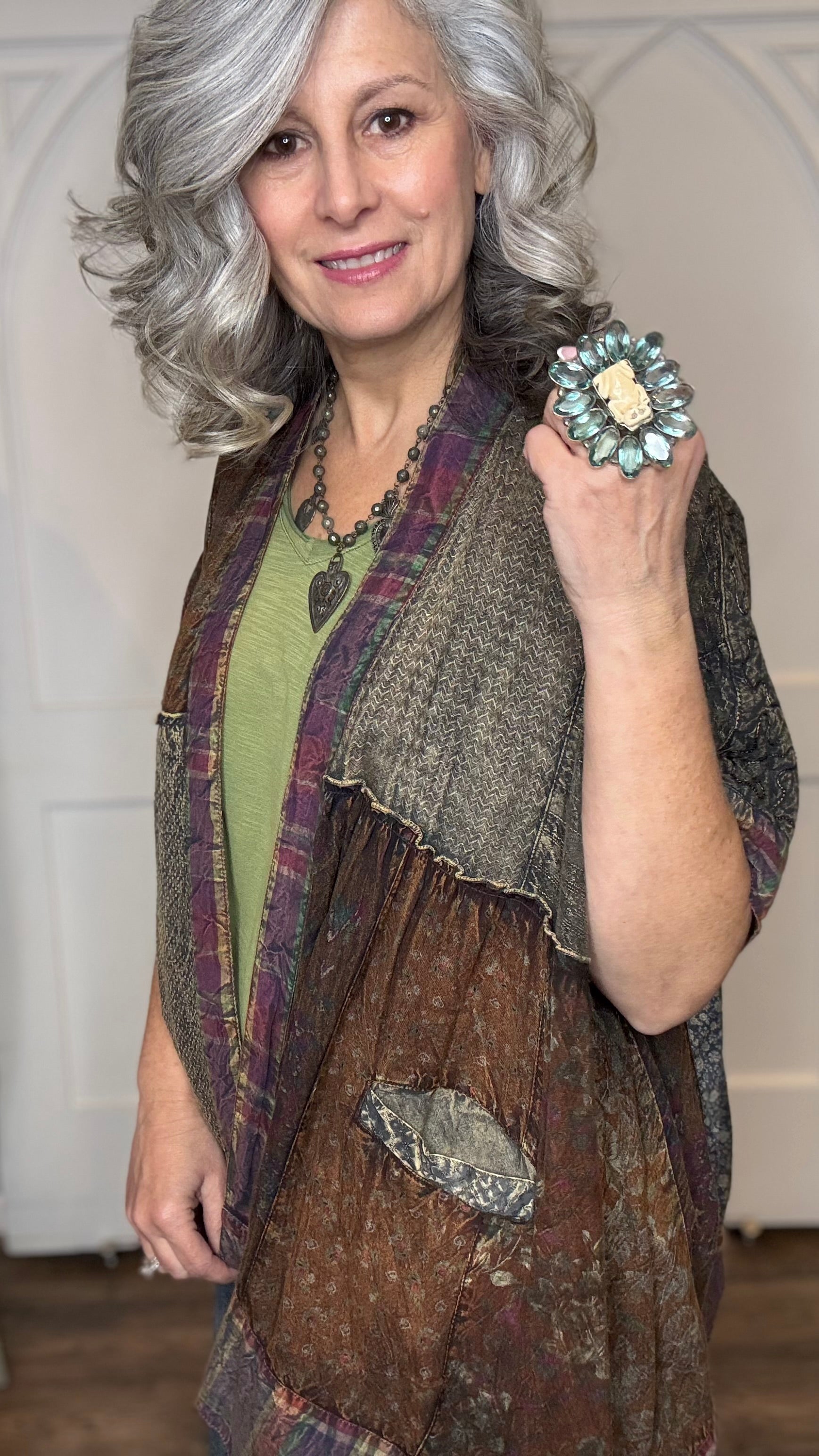 Woman wearing Boho Kimono Shrug Cardigan over a Moon Dance V-Neck in Olive and Judy Blue Palazzo Patch Pocket jeans in front of a white door.