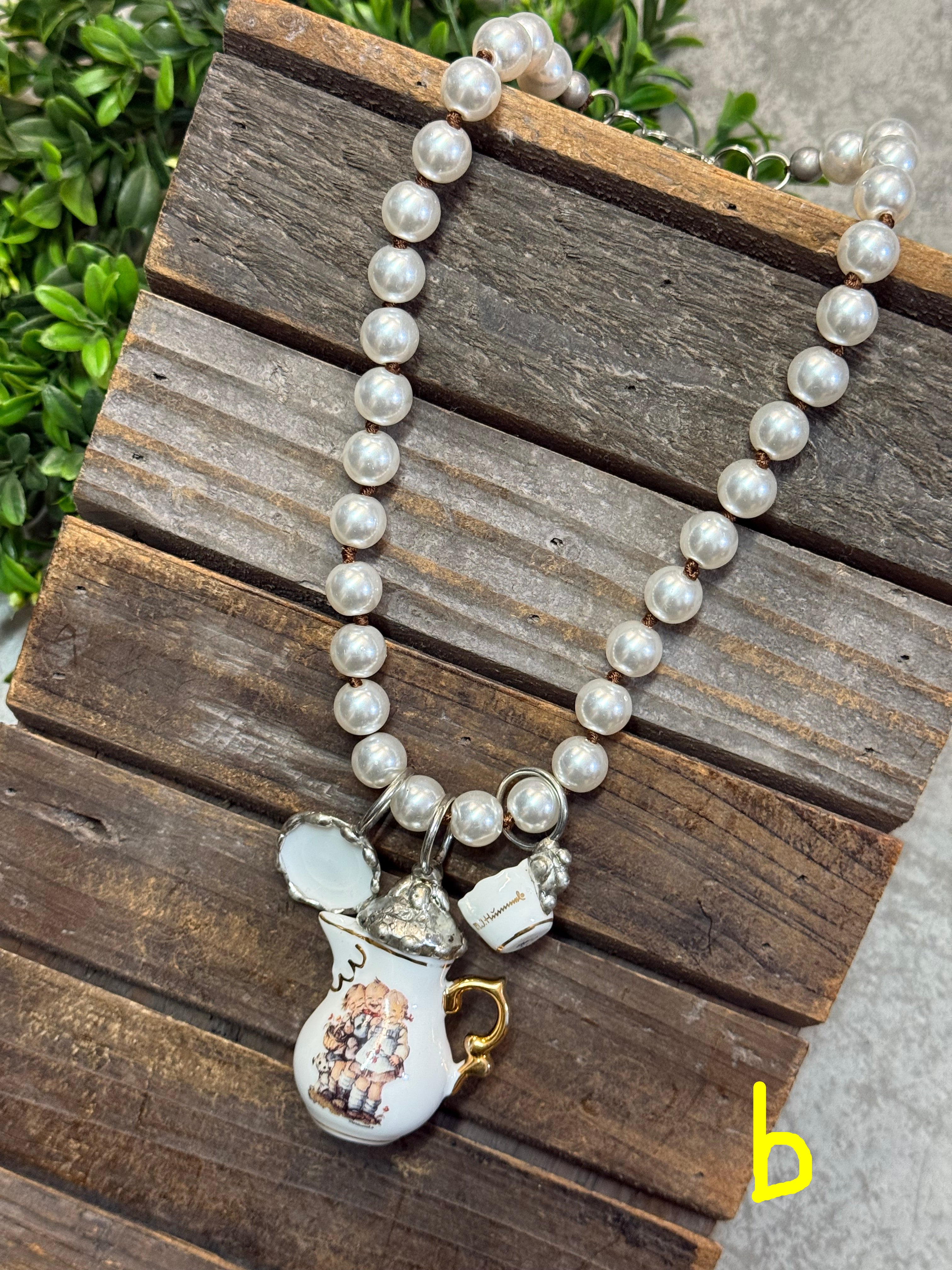 Pearl necklace with a decorative clasp on a wooden surface